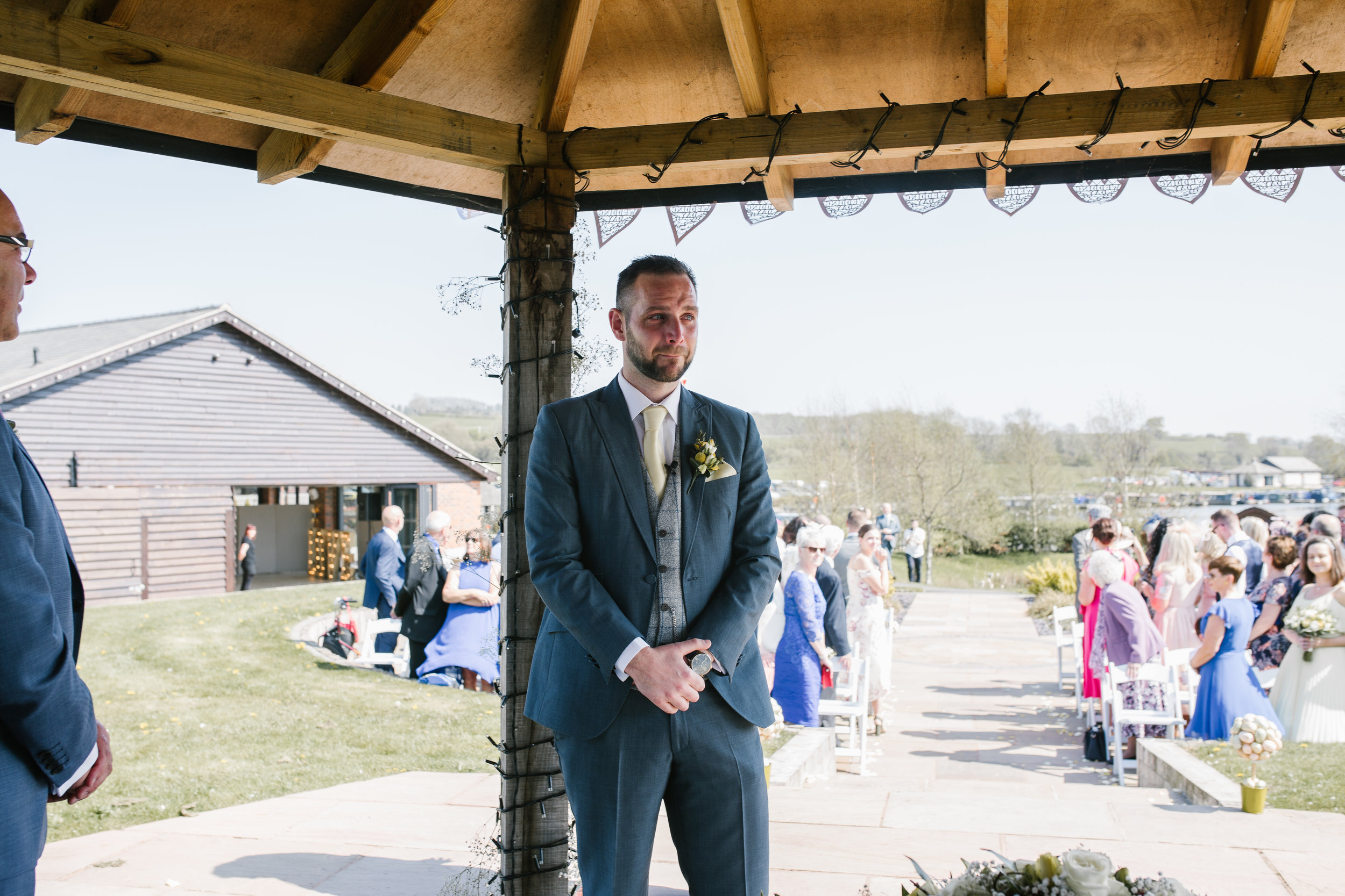 groom waiting for his bride at the outdoor wedding ceremony at the boat house staffordshire