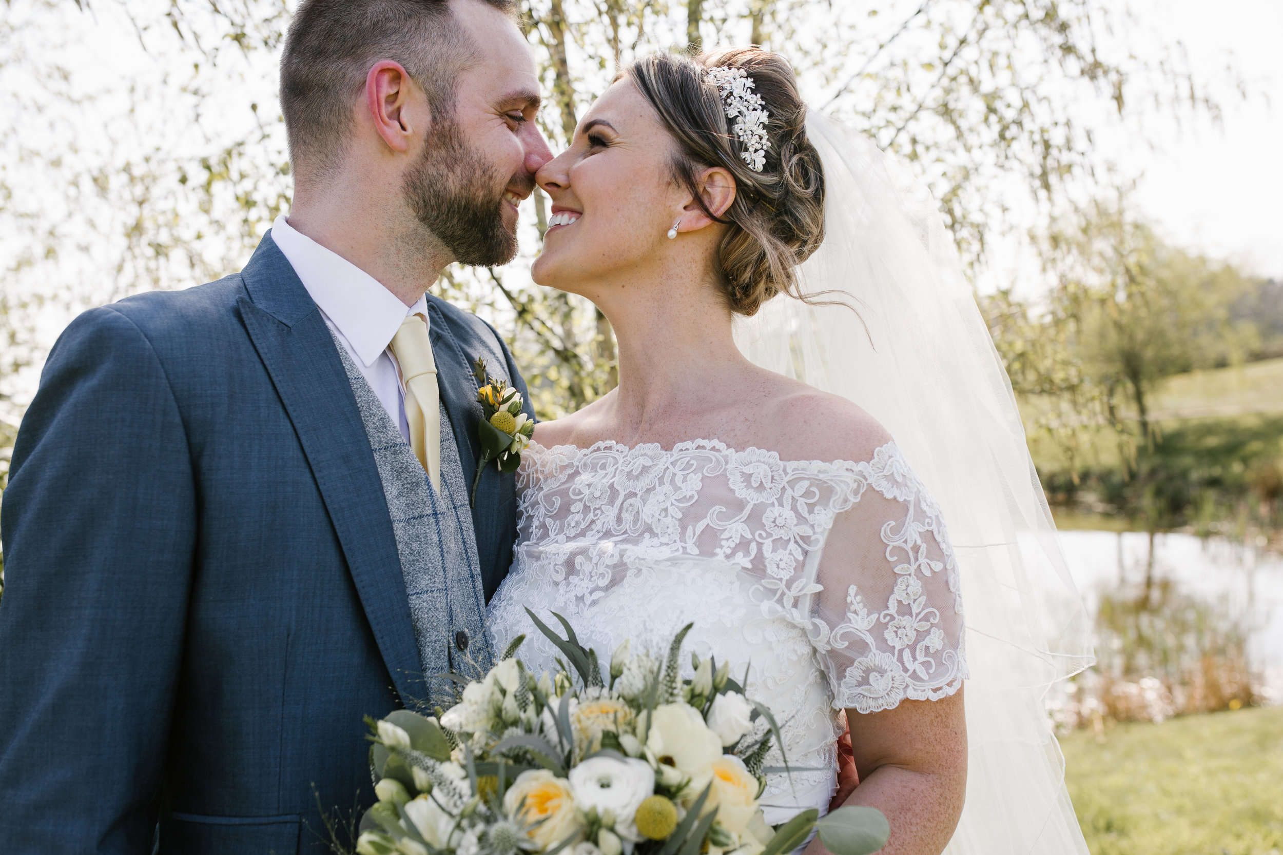 bride and groom smiling happily together after their outdoor wedding