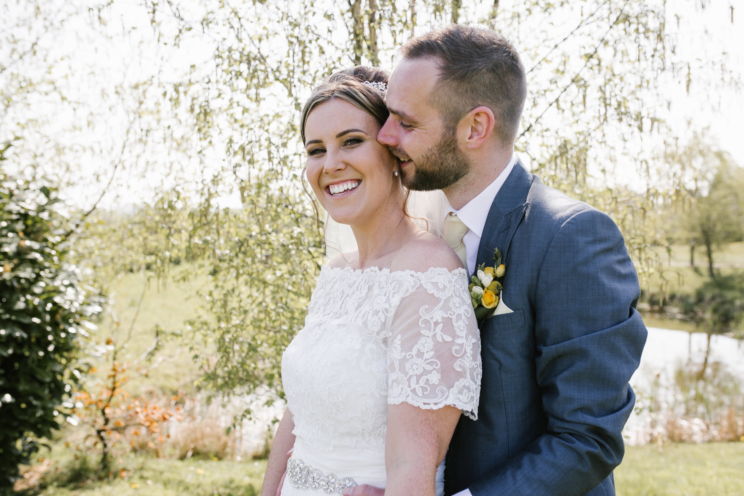 groom kissing the cheek of his new wife 