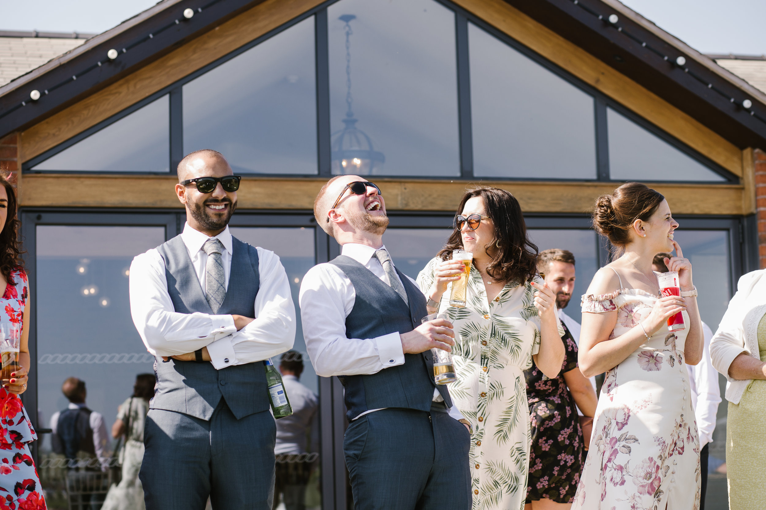 wedding guests laughing at outdoor wedding at aston marina