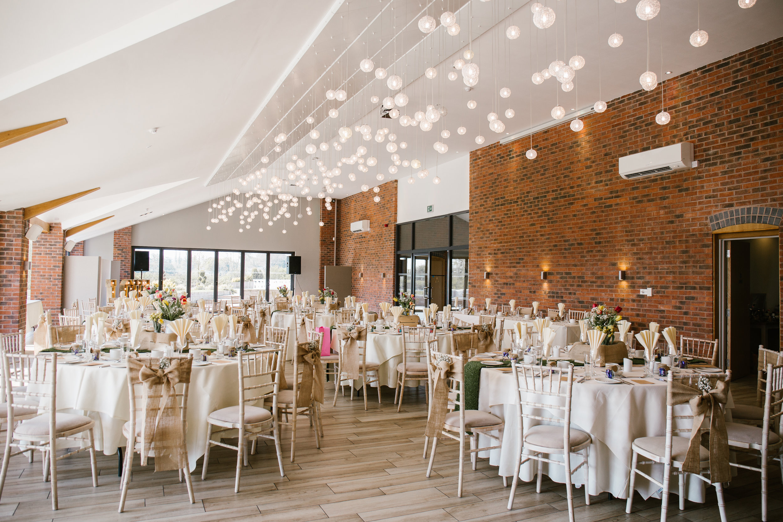 wedding breakfast room set up at the boat house aston marina for a spring themed wedding