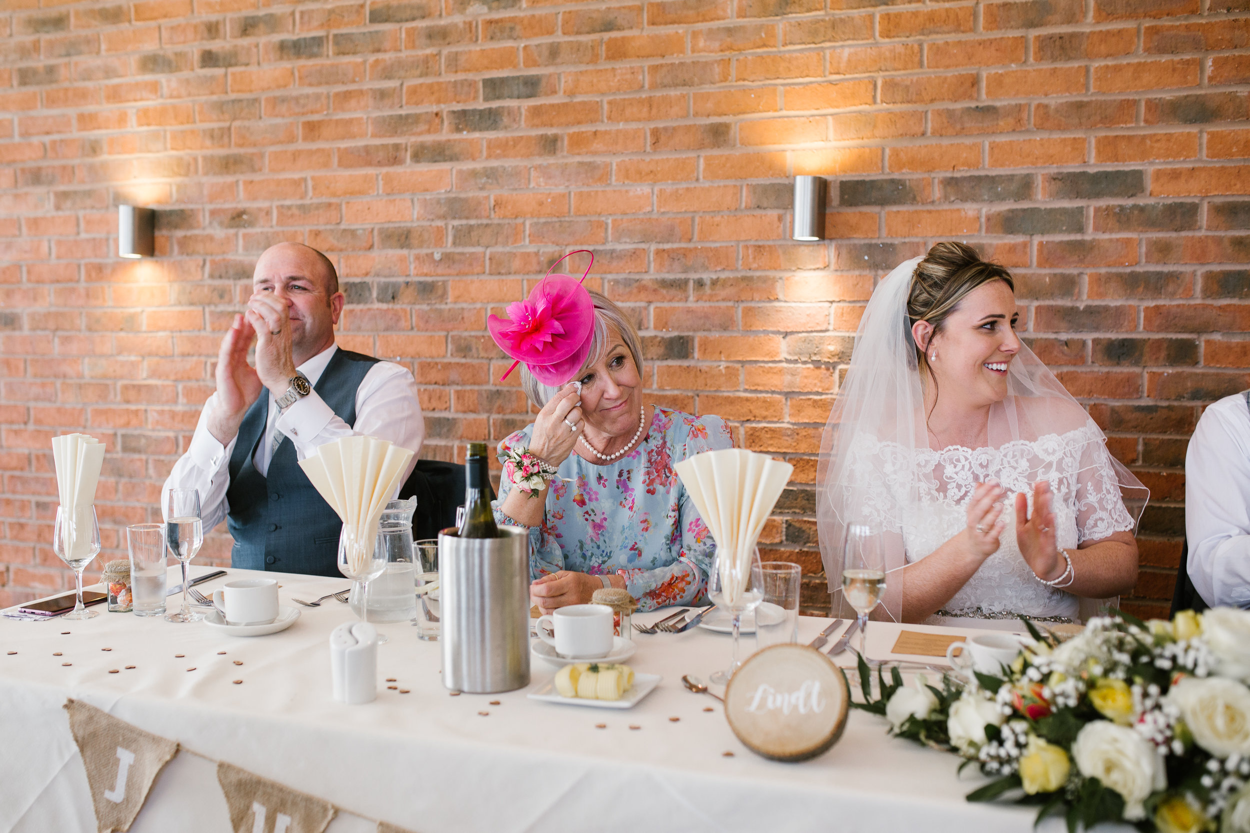 mother of the bride laughing during the grooms wedding speech