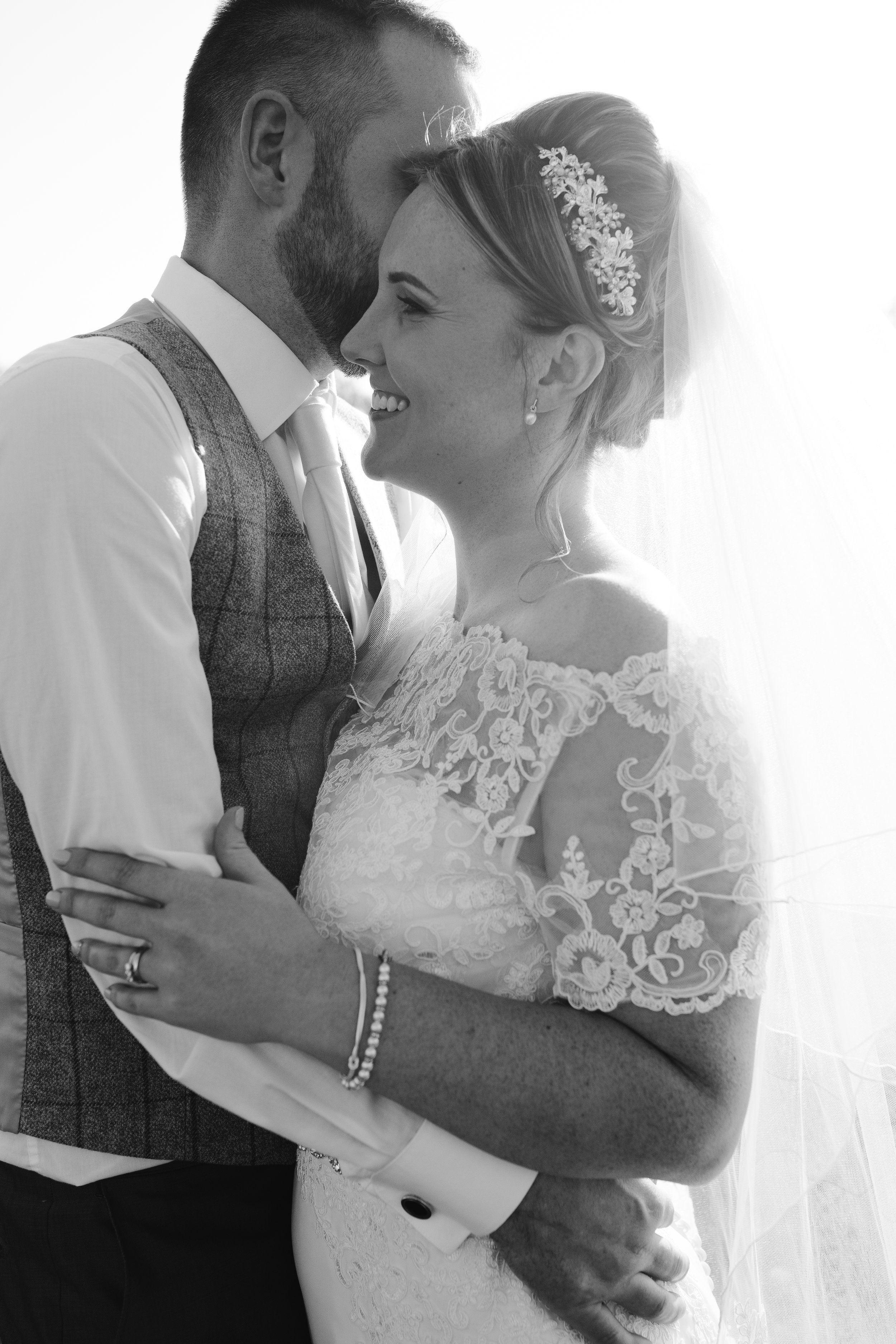 black and white photo of newlyweds snuggling together at their aston marina wedding