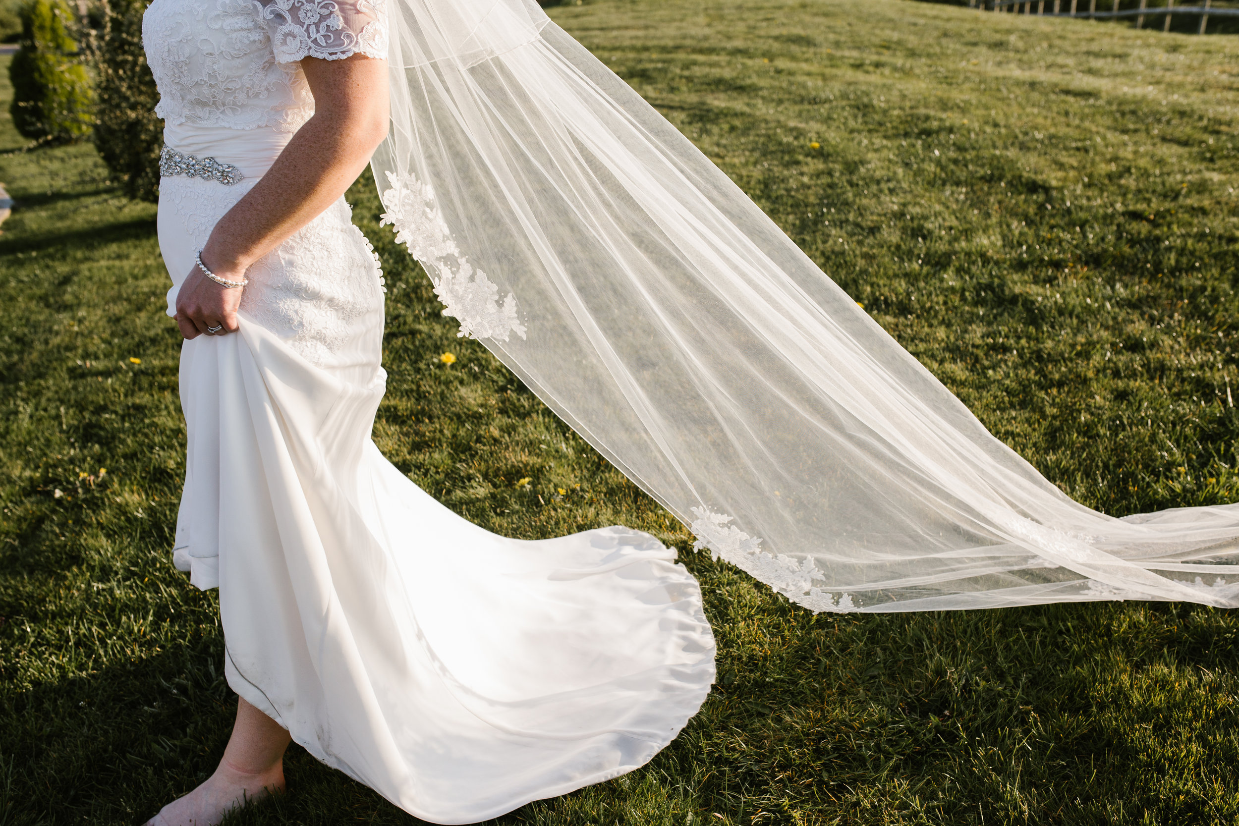 golden light falling on the brides veil and dress on the evening of their wedding