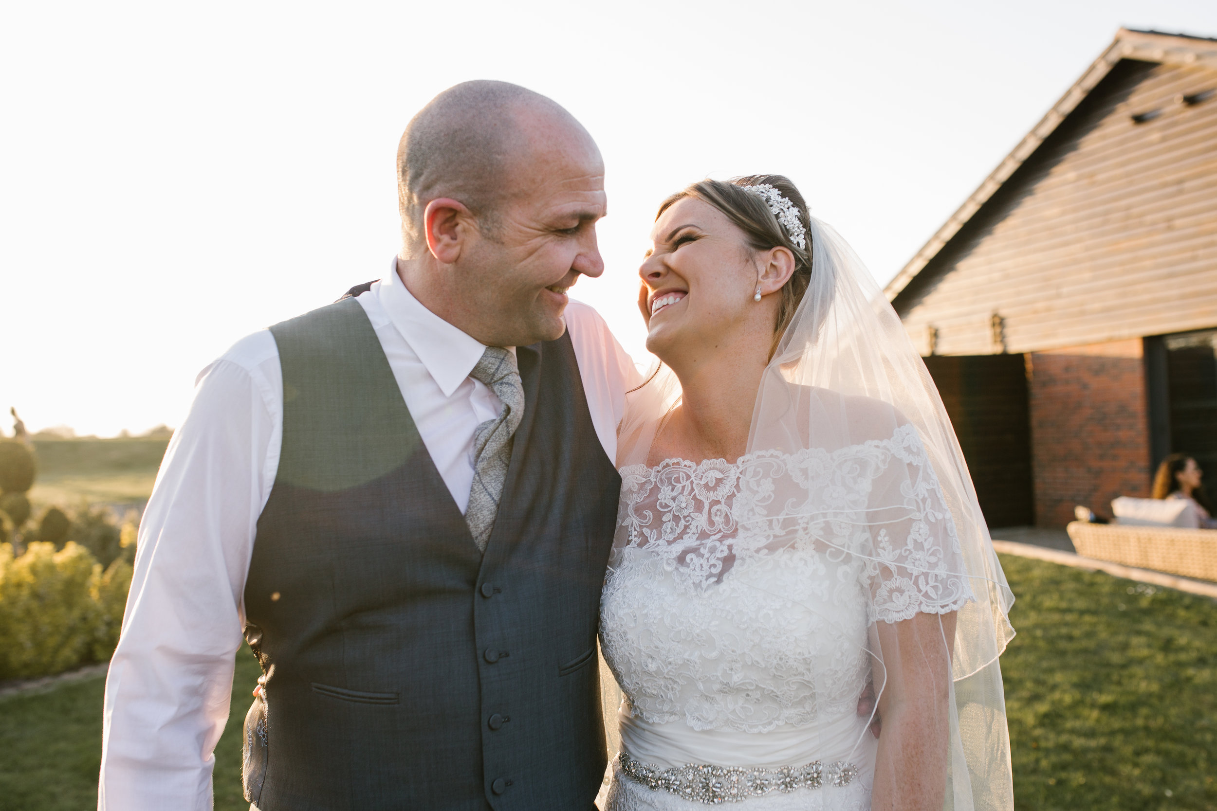 bride with her father of the bride laughing together on the evening of their wedding at aston marina staffordshire