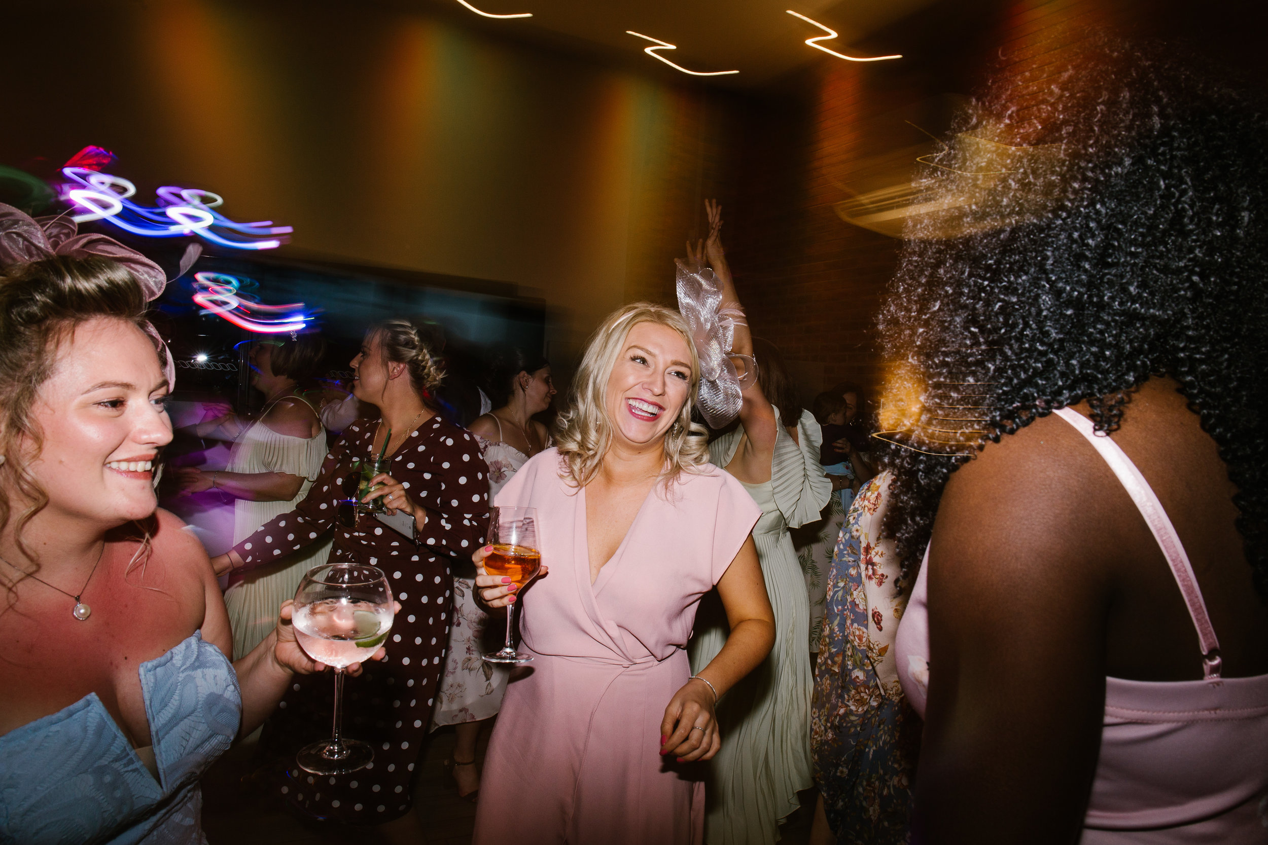 wedding guest dancing on the dance floor at the boat house