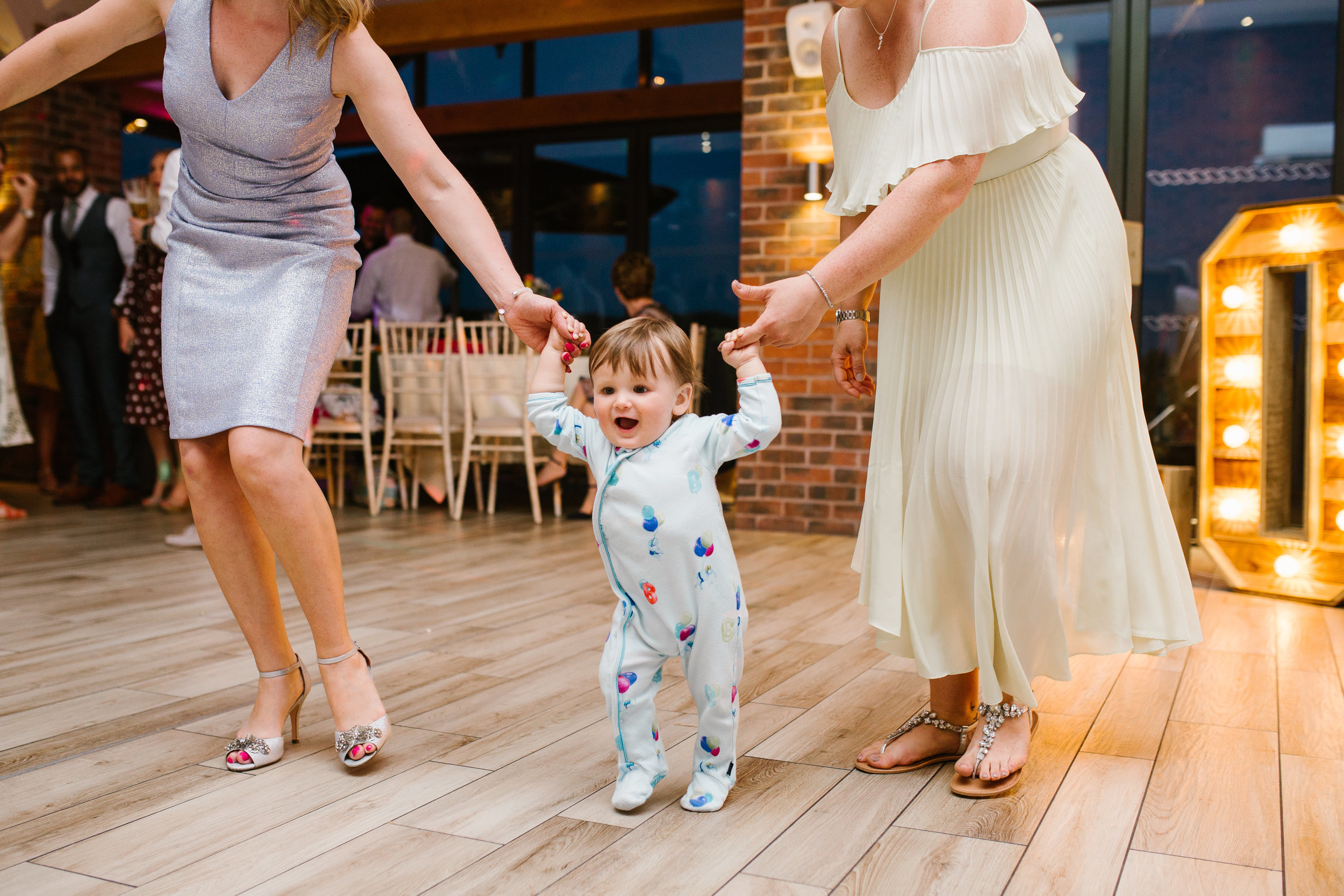 little toddler dancing in his onesie on the dance floor at aston marina