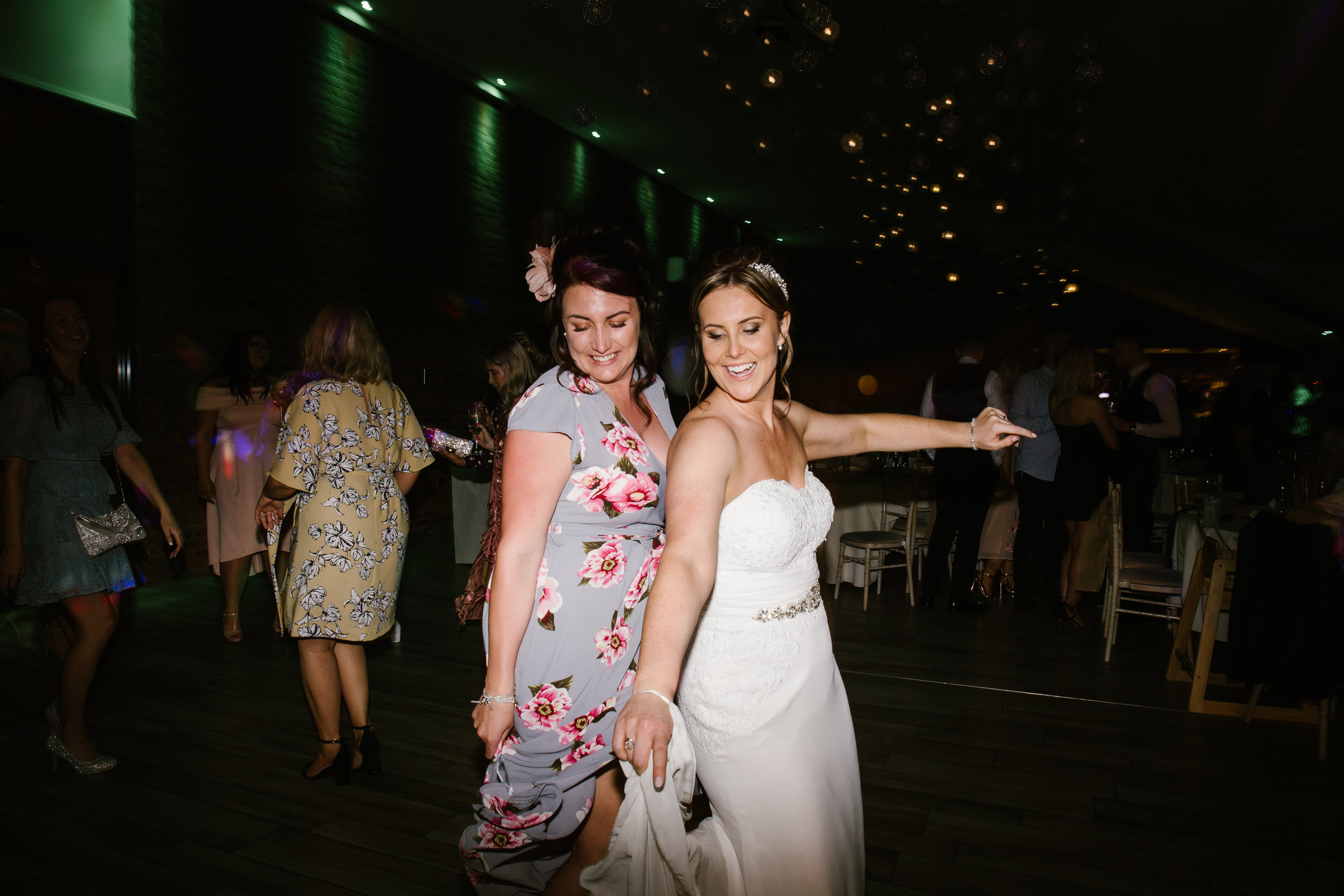 wedding guest dancing with the bride at the wedding party at the boat house in staffordshire