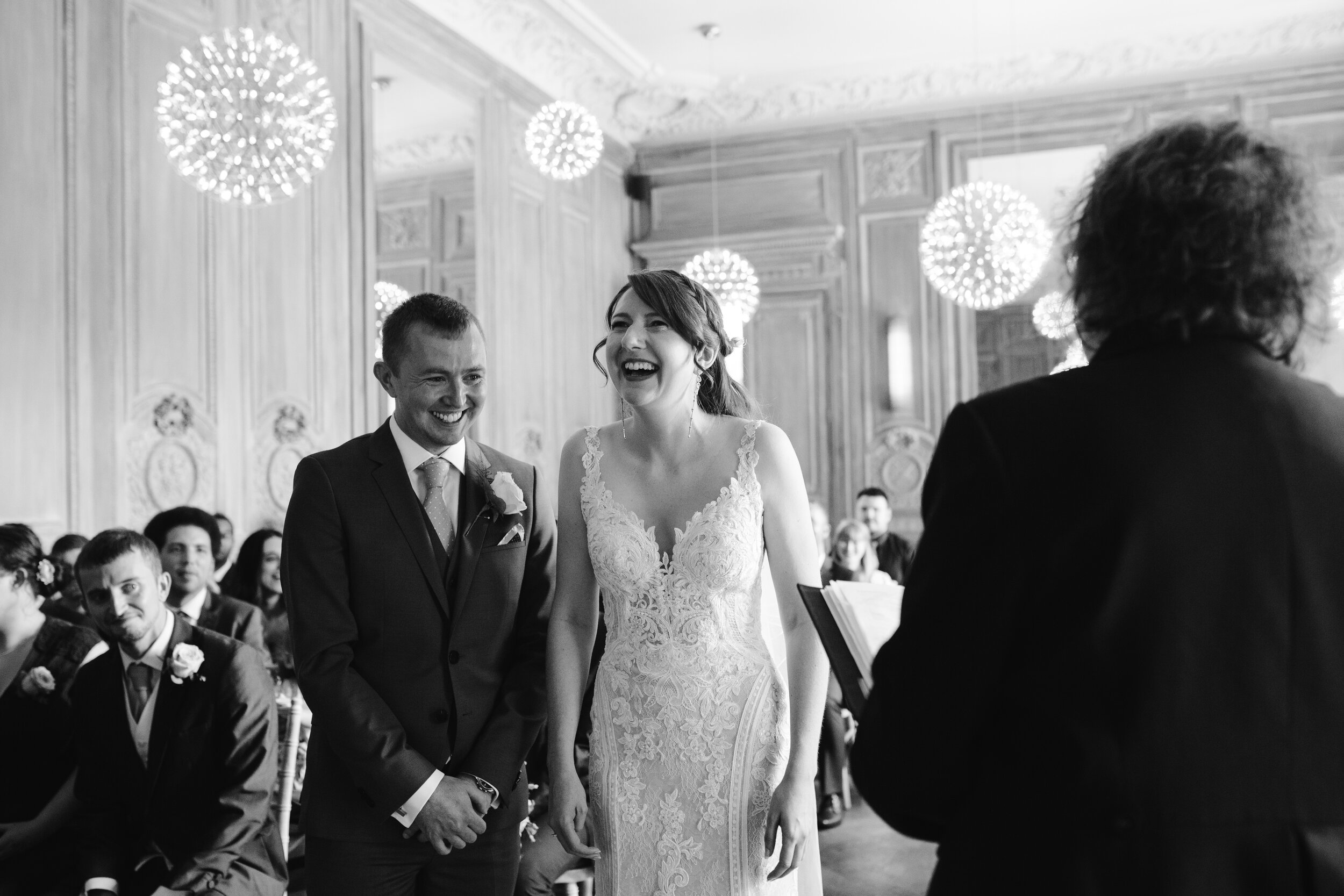 bride and groom laughing together during their wedding ceremony at cowley manor