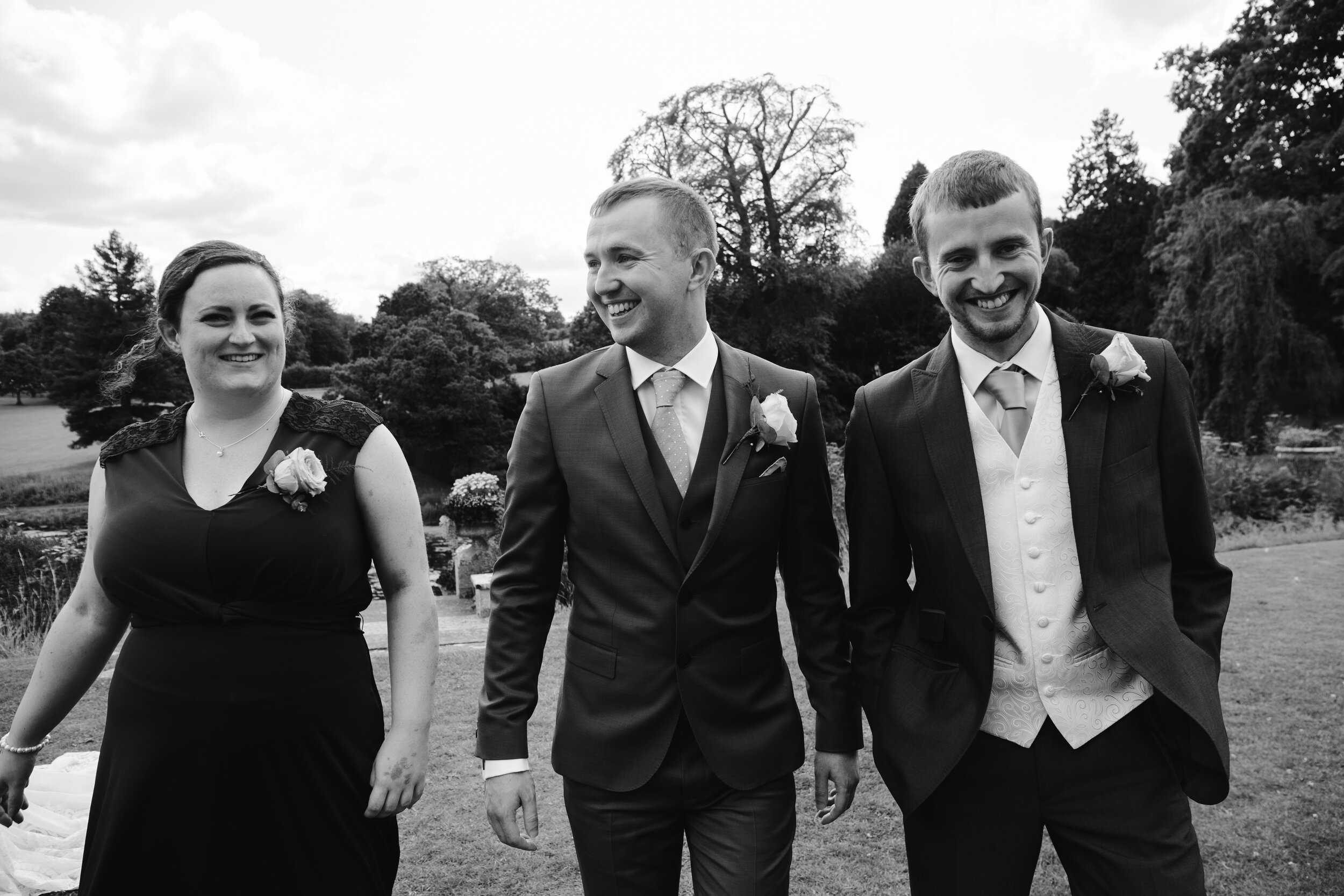 natural black and white photo of groom with his best men