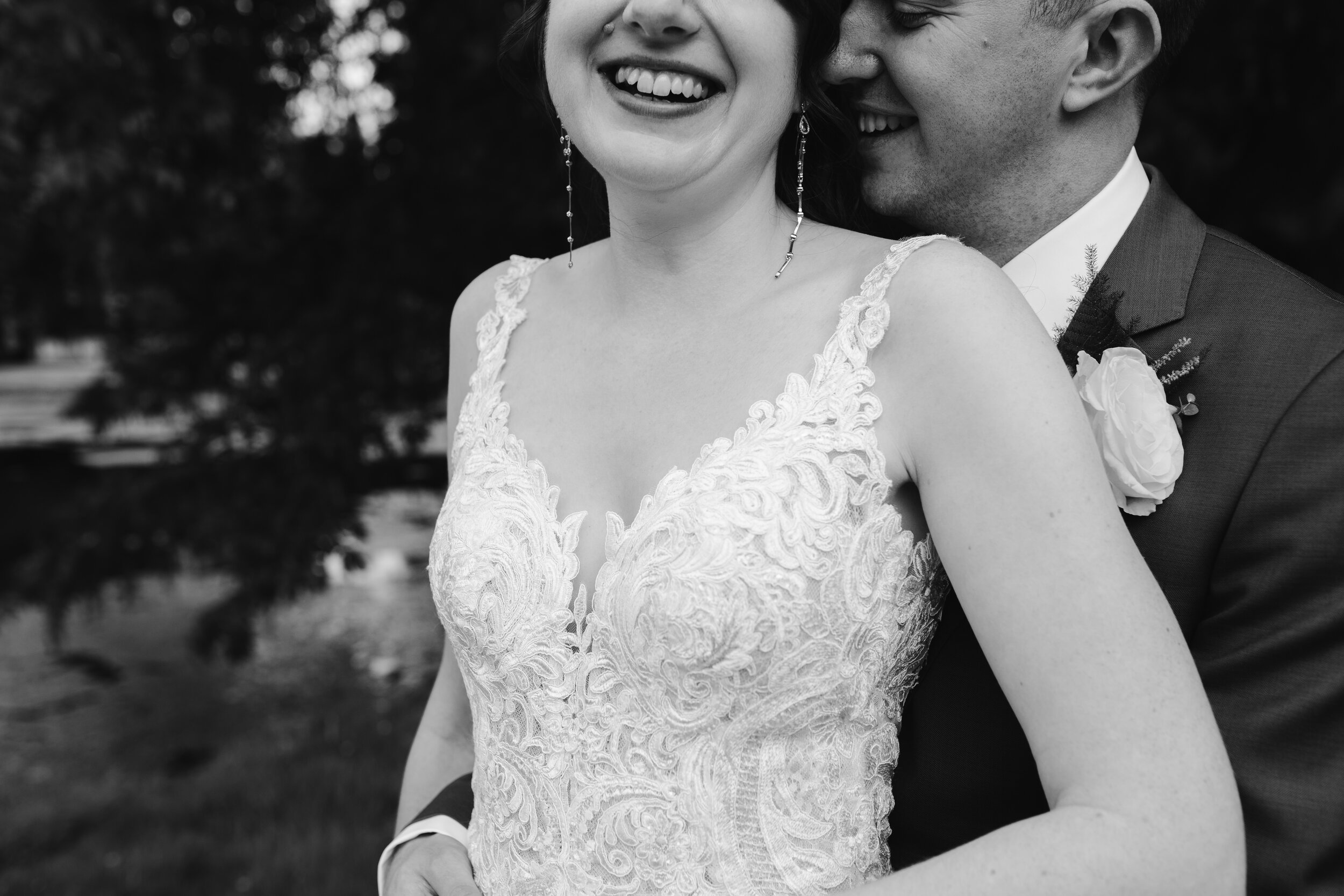 close up detail shot of bride and groom laughing together 
