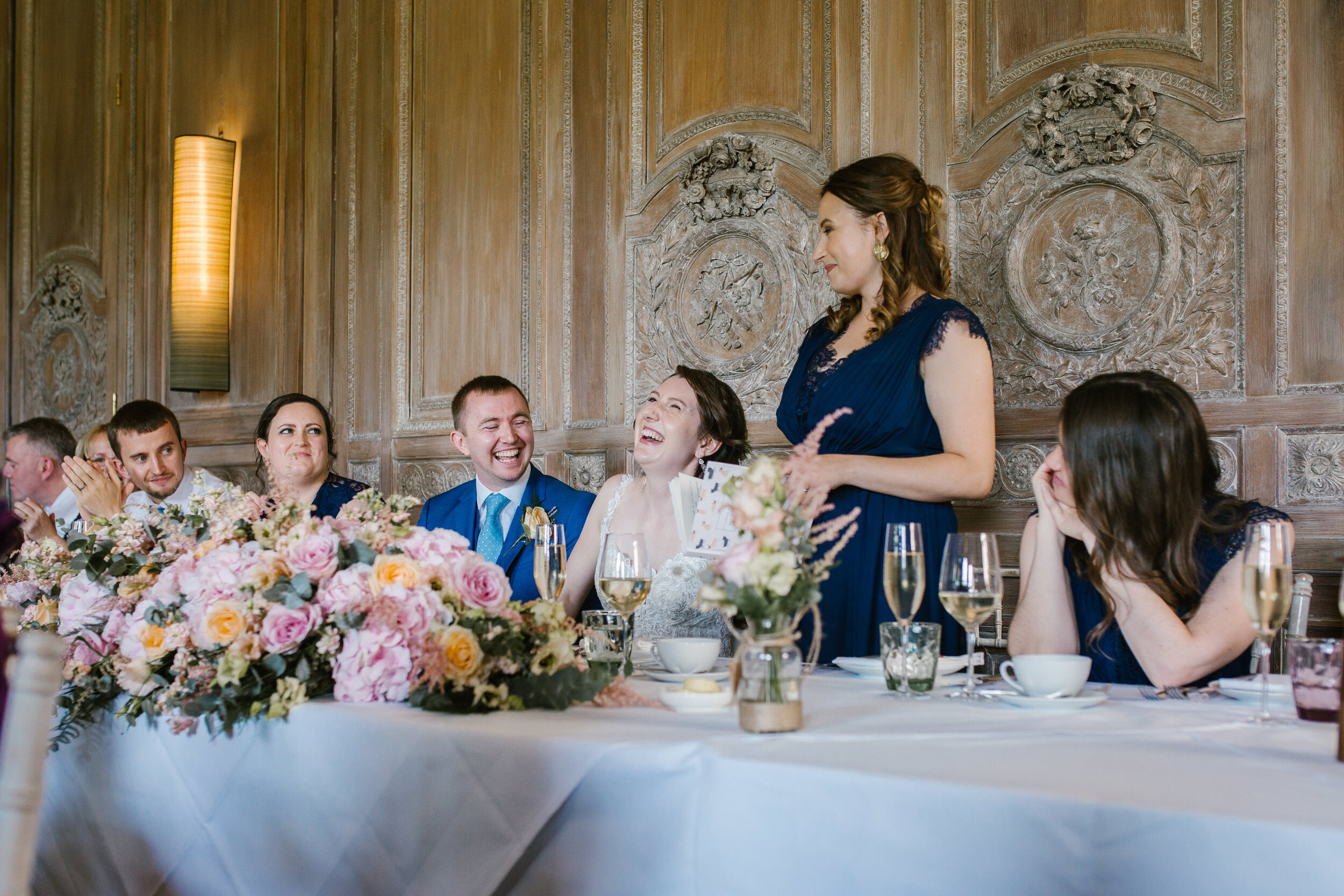 natural photo of the maid of honour laughing during her speech