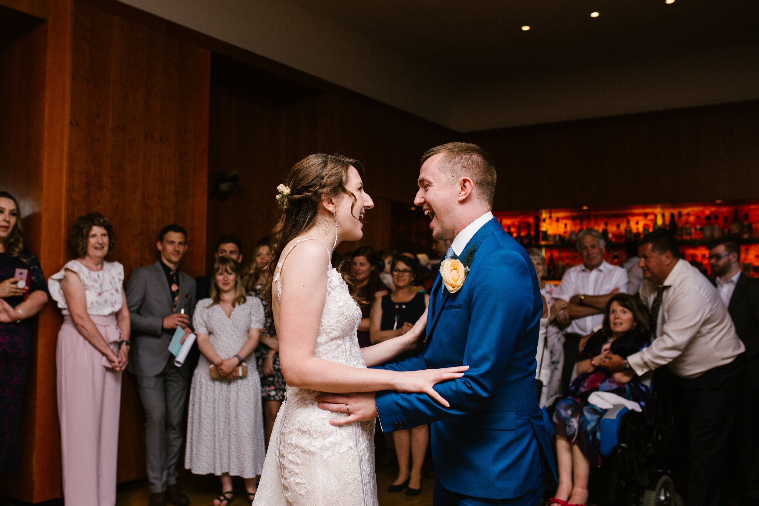 bride and groom laughing together during their first dance at cowley manor