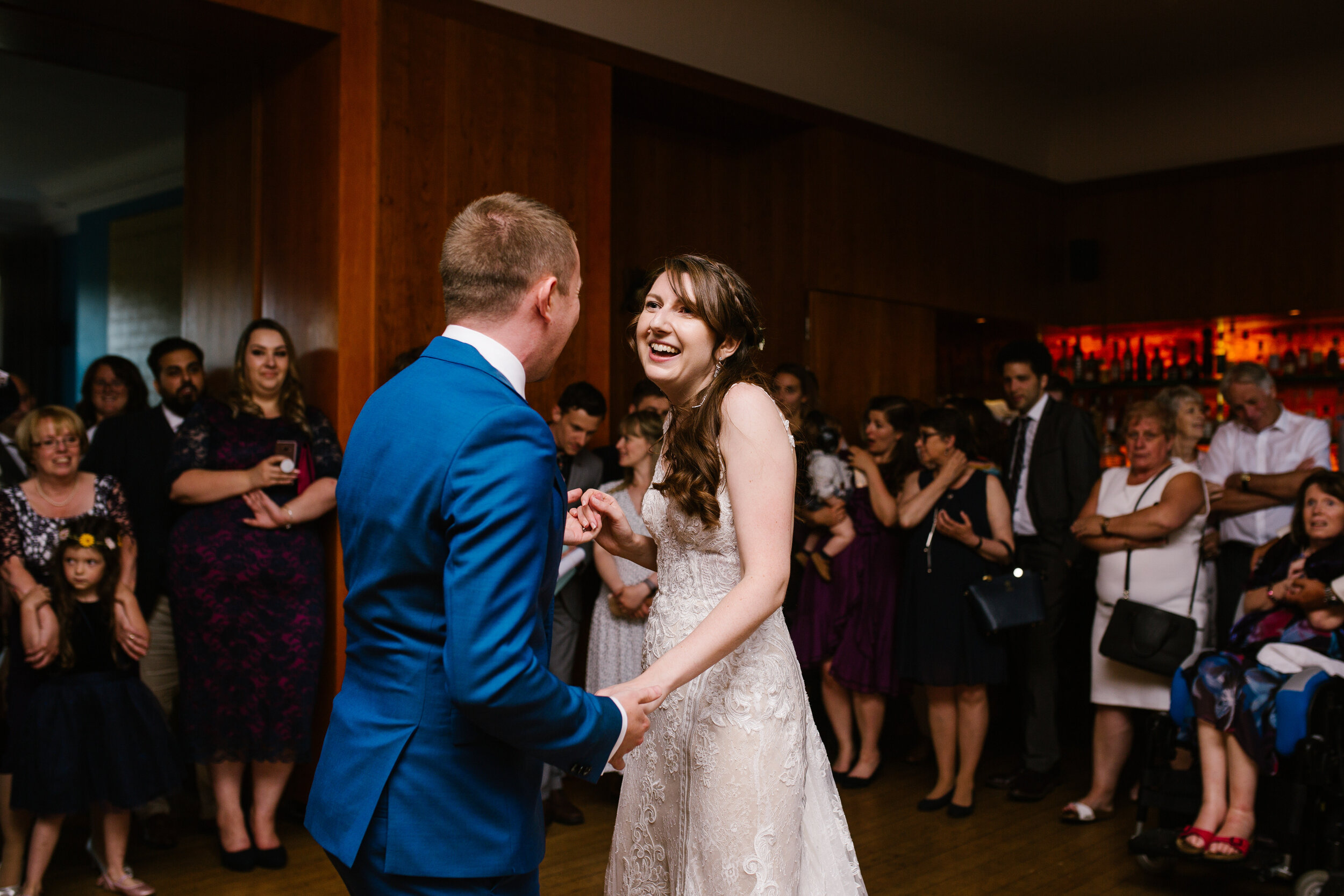 fun photo of newlyweds dancing together during their first dance at cowley manor