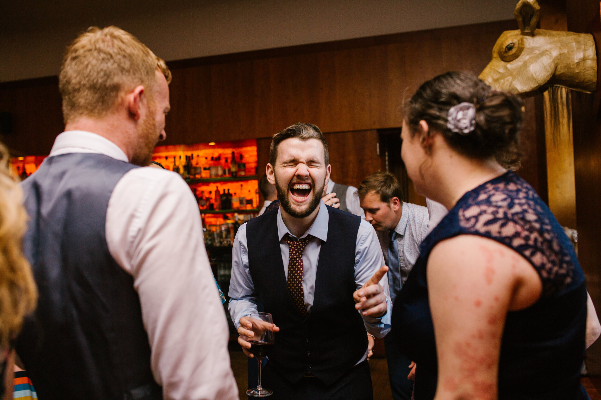 wedding guests laughing at the wedding reception at cowley manor 