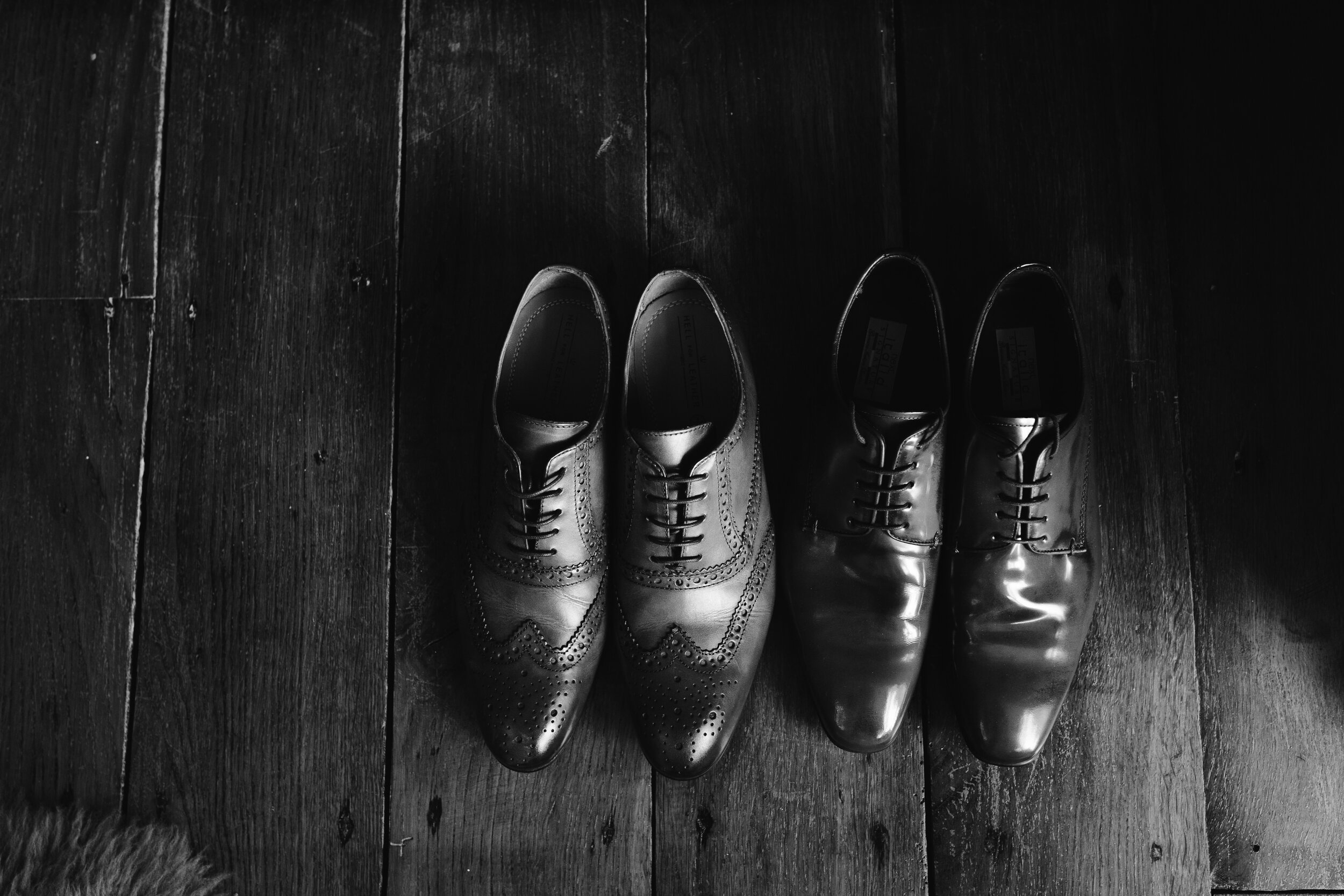 black and white photo of brown leather wedding shoes for the groom
