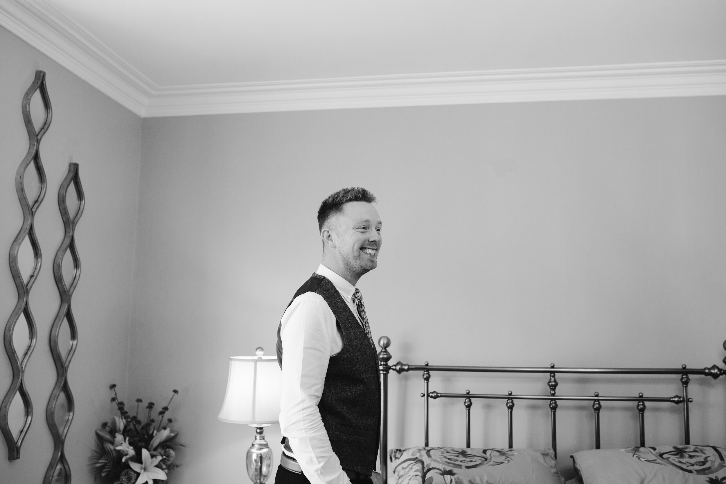 beautoful photo of the groom smiling at his husband to be 