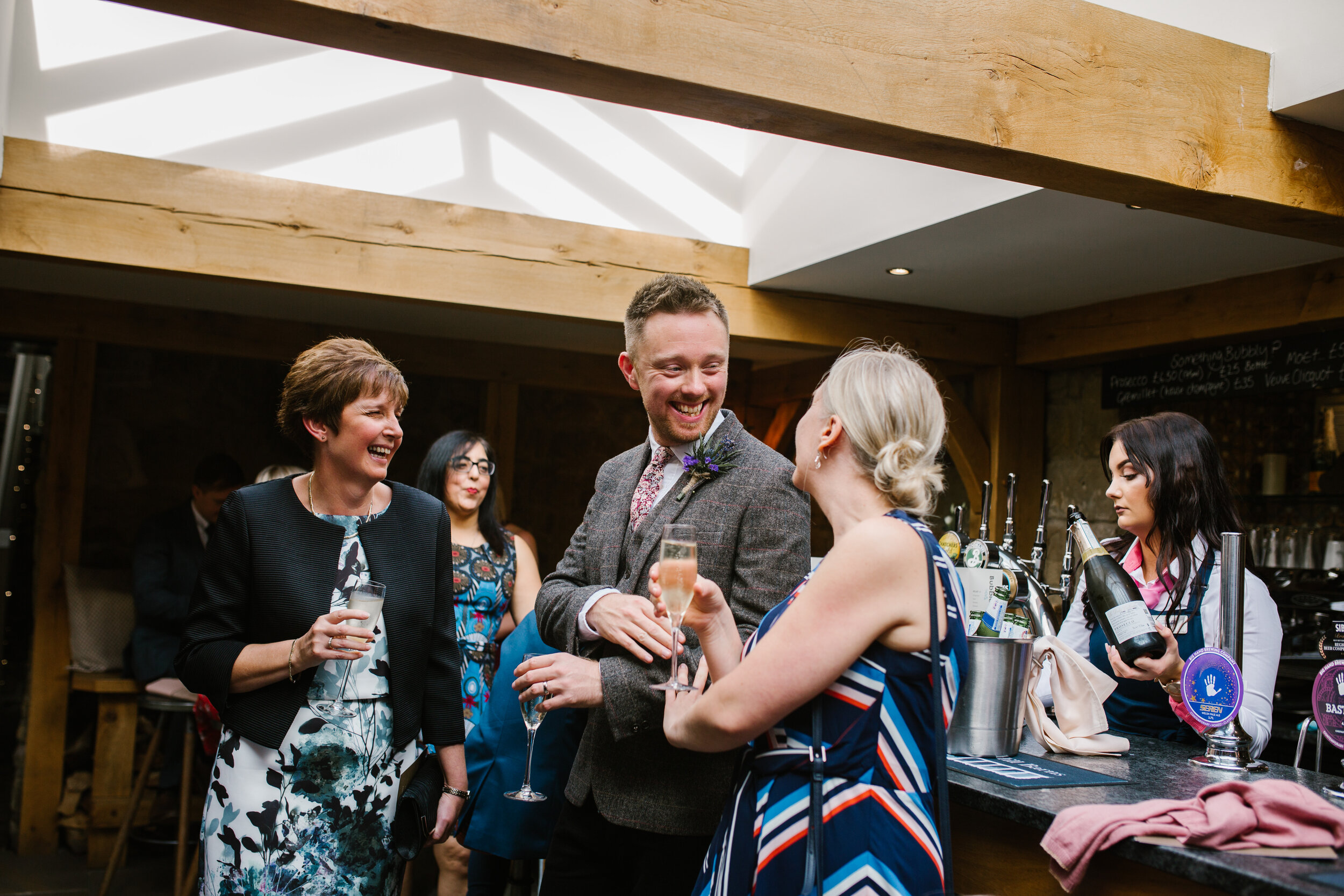a candid photo of the groom mingling with his guests at their wedding at tower hill barns