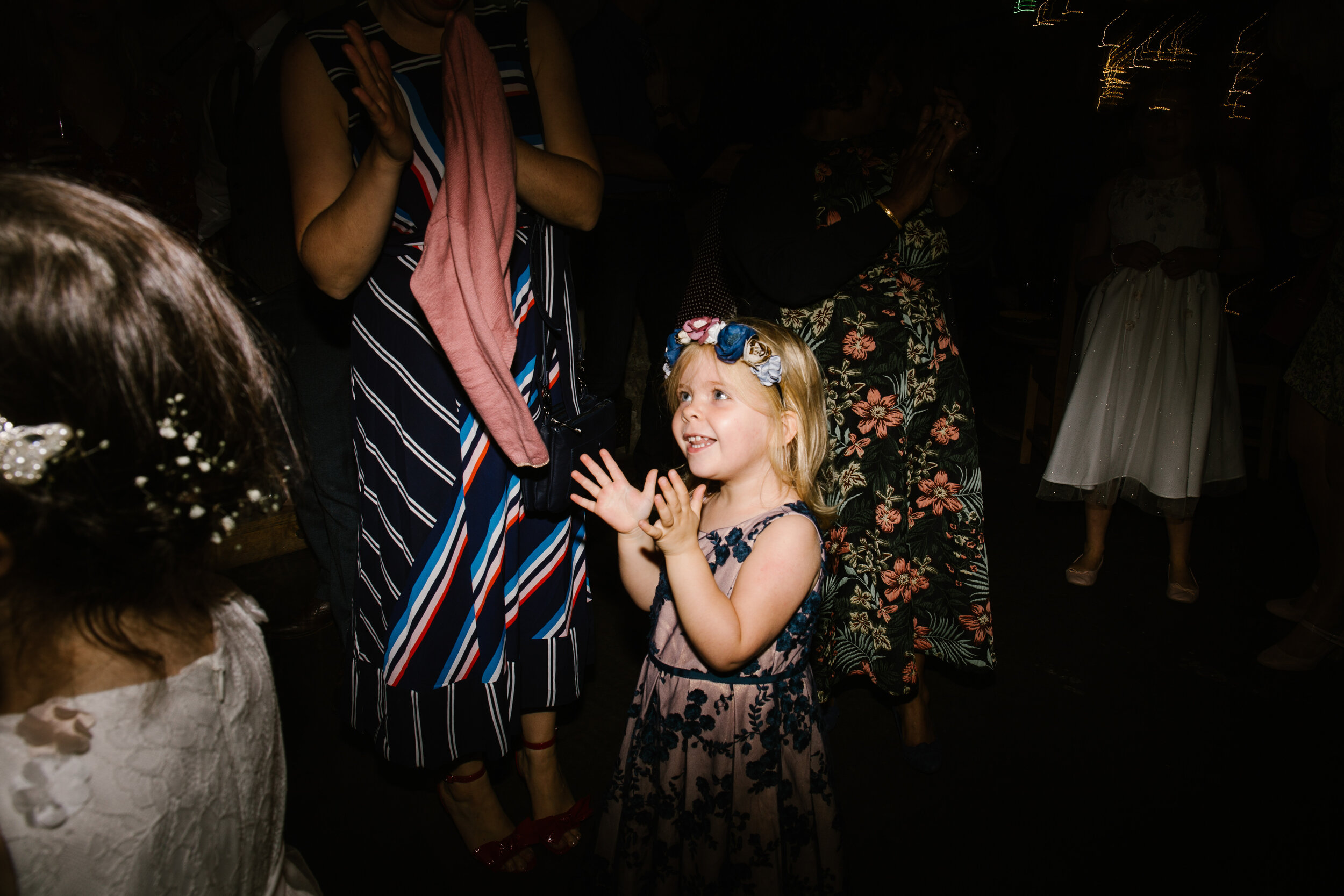 little girl dancing and clapping on the dance floor at tower hill barns wedding