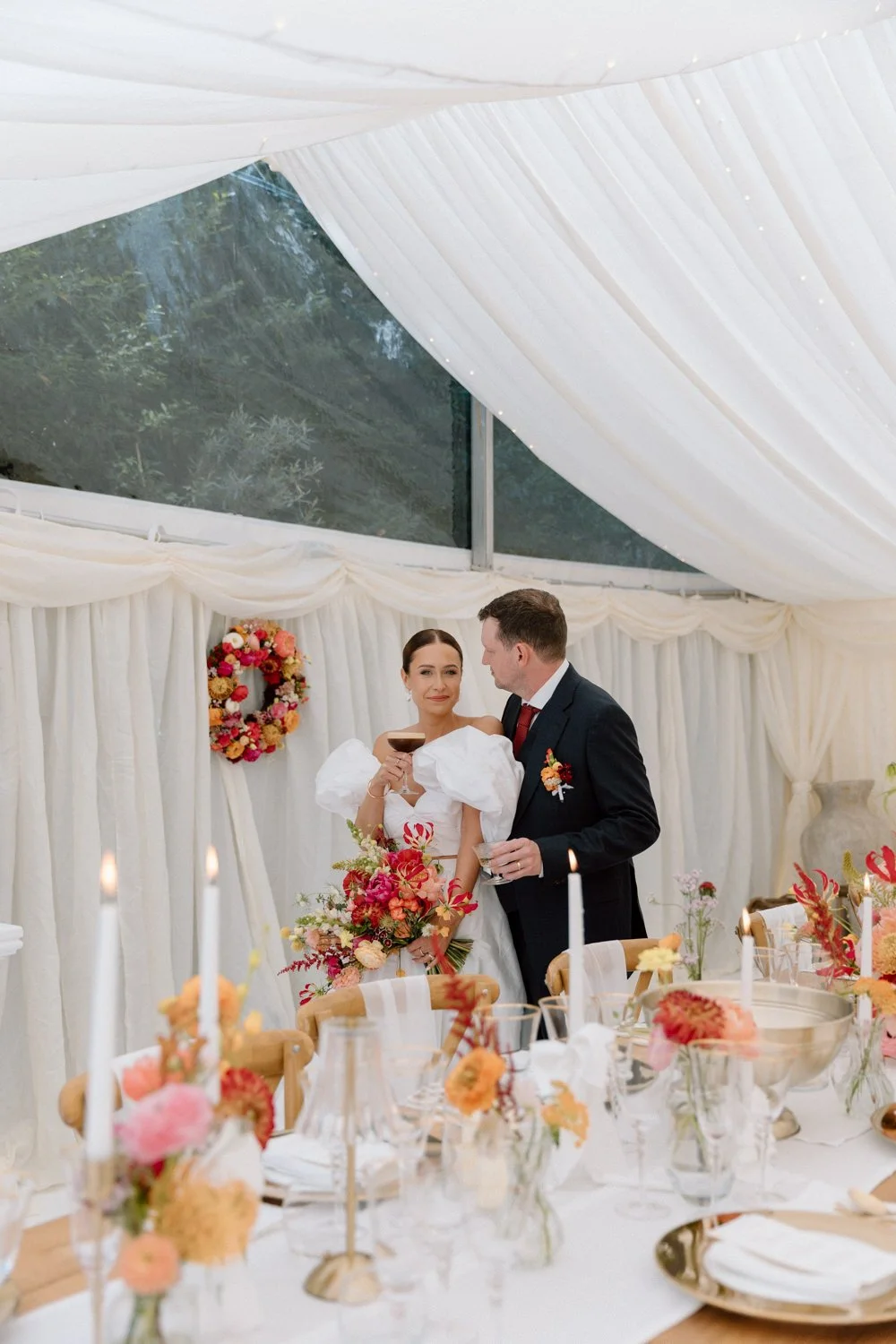 Bride and groom in a colourful marquee
