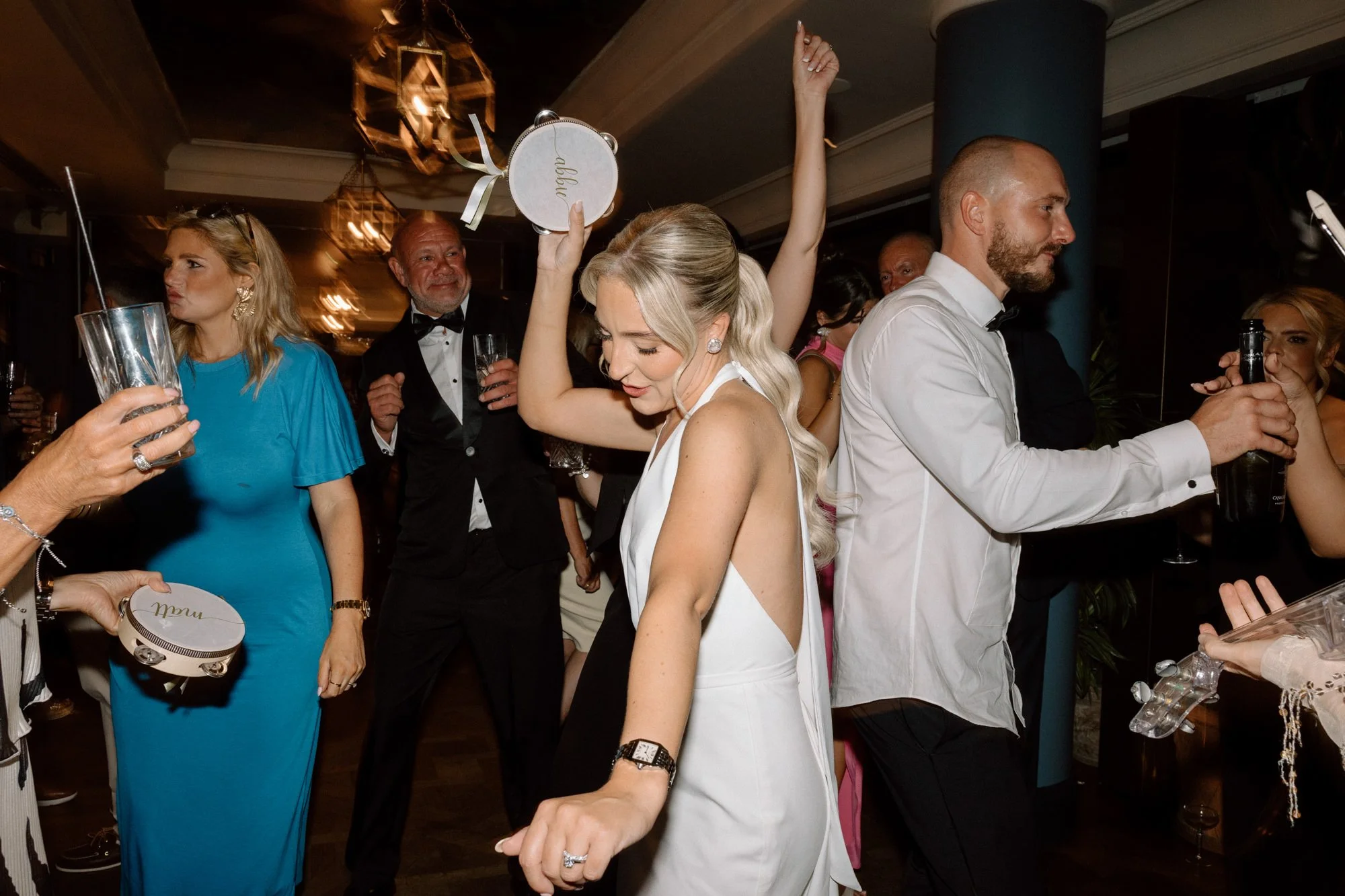 Bride dancing on the dancefloor at The Ivy Tower Bridge dancing with a tamborine