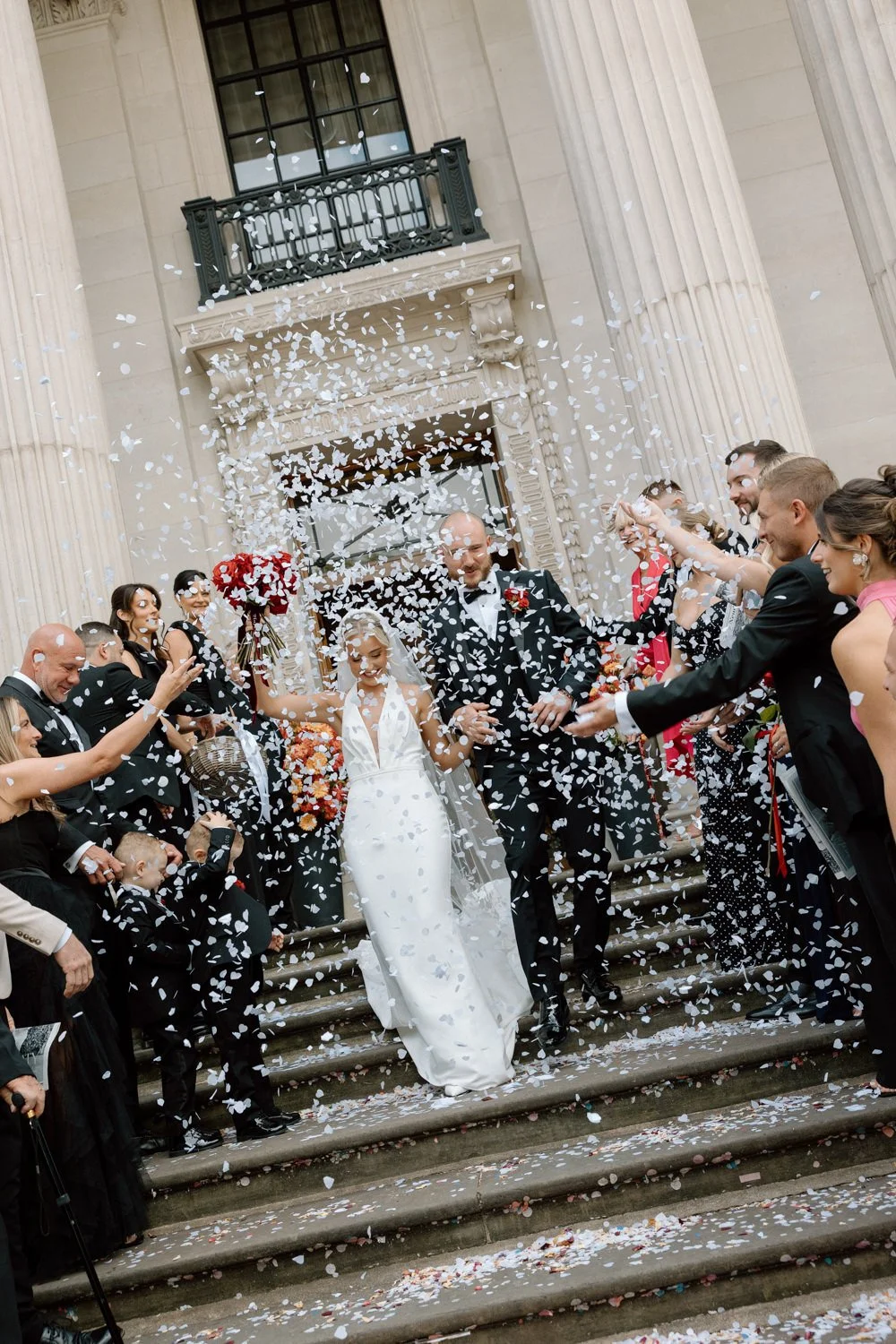 Confetti photo of a bride and groom walking down the steps at the Old Marylebone Town Hall