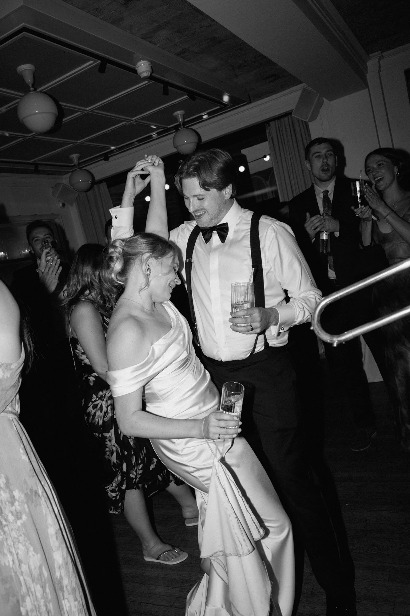 Black and white image of bride and groom doing their first dance to a jazz band at mortimer house in london