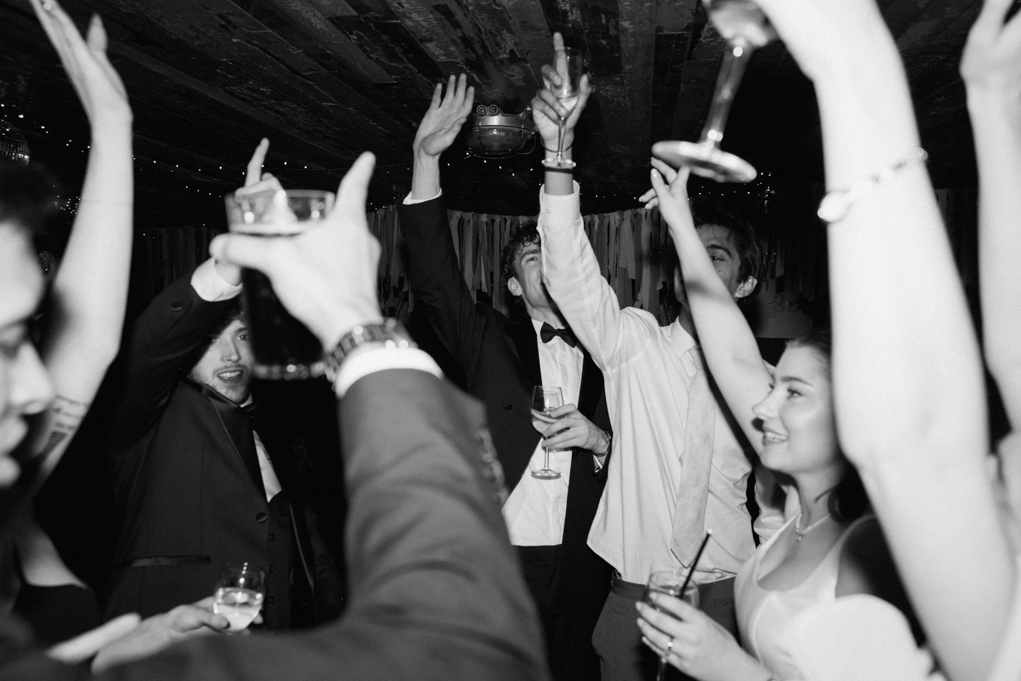 Black and white image of wedding party on the dancefloor