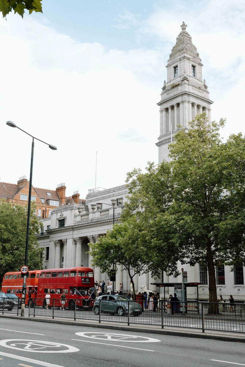 The Old Marylebone Town Hall on a summer day with a double decker red bus outside