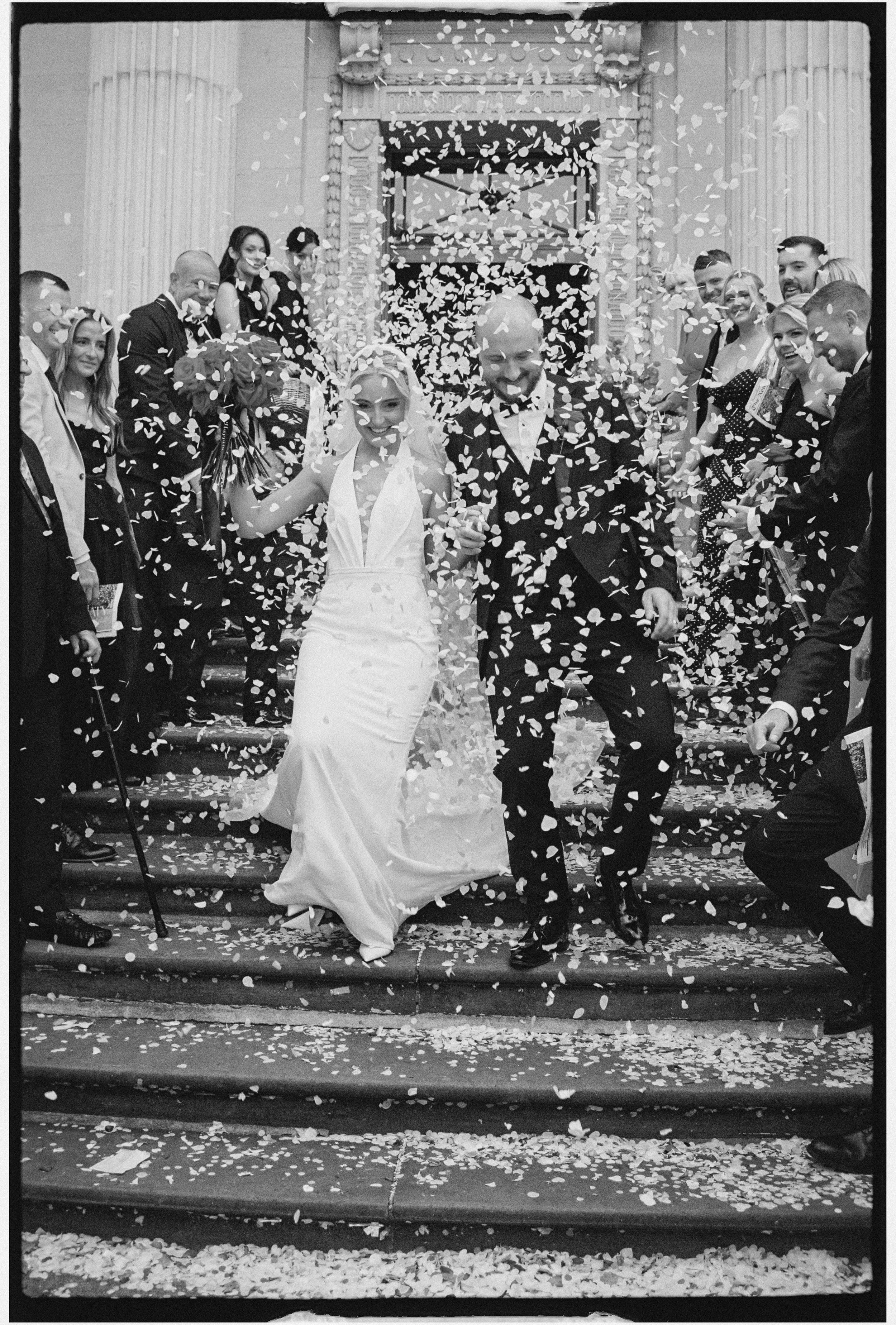 Black and white 35mm photo of confetti on the steps at Marylebone Town Hall