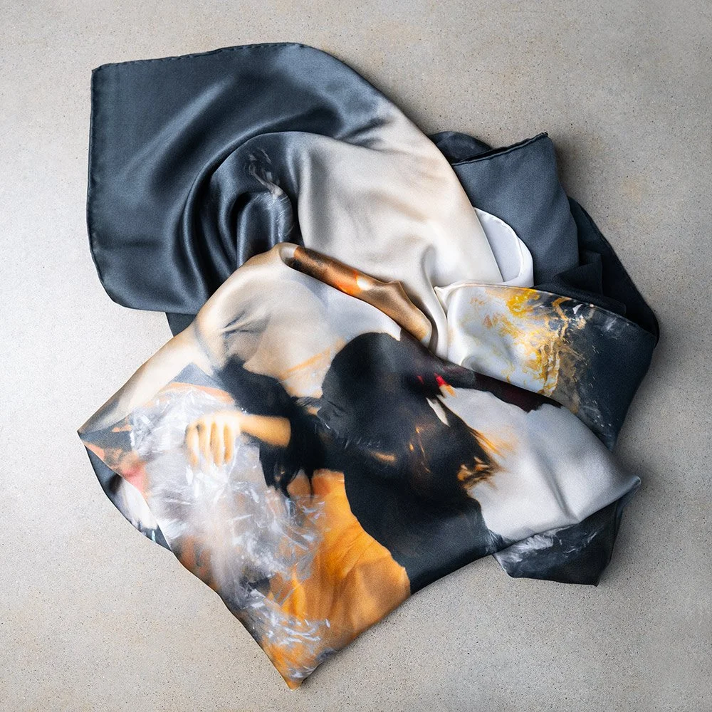 Christy Lee Rogers’ Shine silk scarf from her Muses collection captures the ethereal beauty of underwater figures, reminiscent of Renaissance masterpieces.