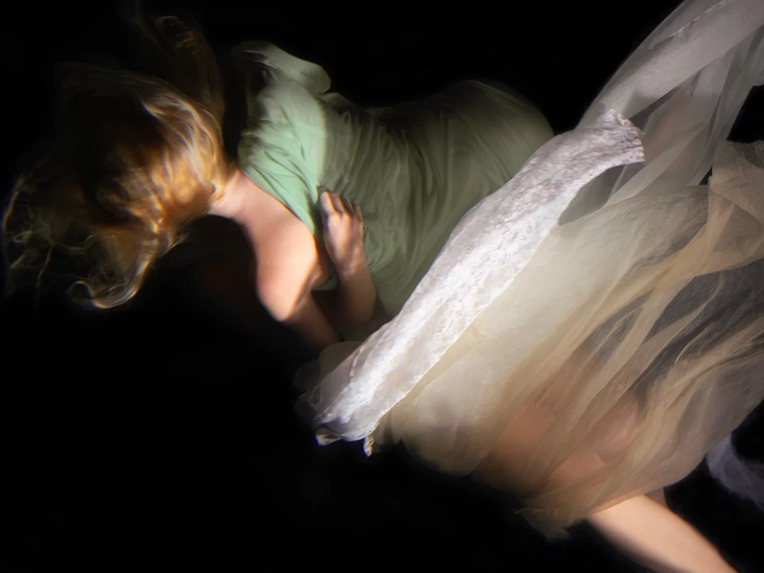 Two figures merge into one beneath the water’s surface, their forms dissolving together in a mysterious, fluid embrace. Christy Lee Rogers uses dark chiaroscuro to heighten the drama.