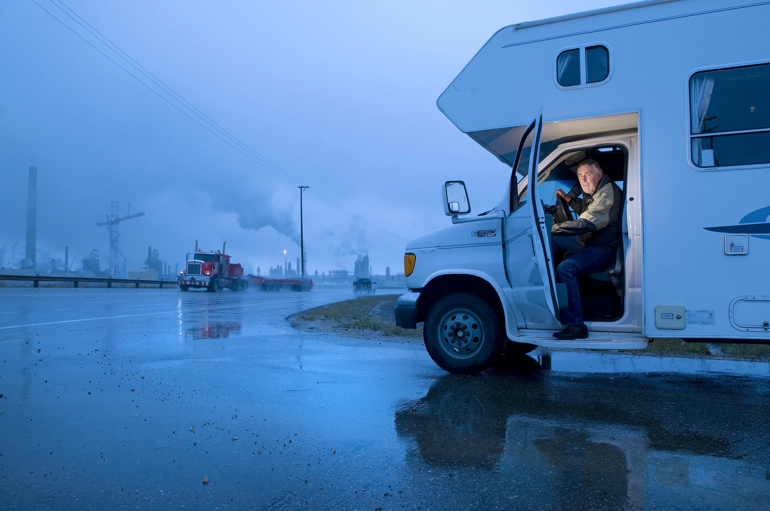  Fort McMurray, Alberta, Canada - August 13, 2008 - John Griffiths parks his RV near rows of oil refineries in Fort McMurray, Alberta, Canada. Photo by Jimmy Jeong 