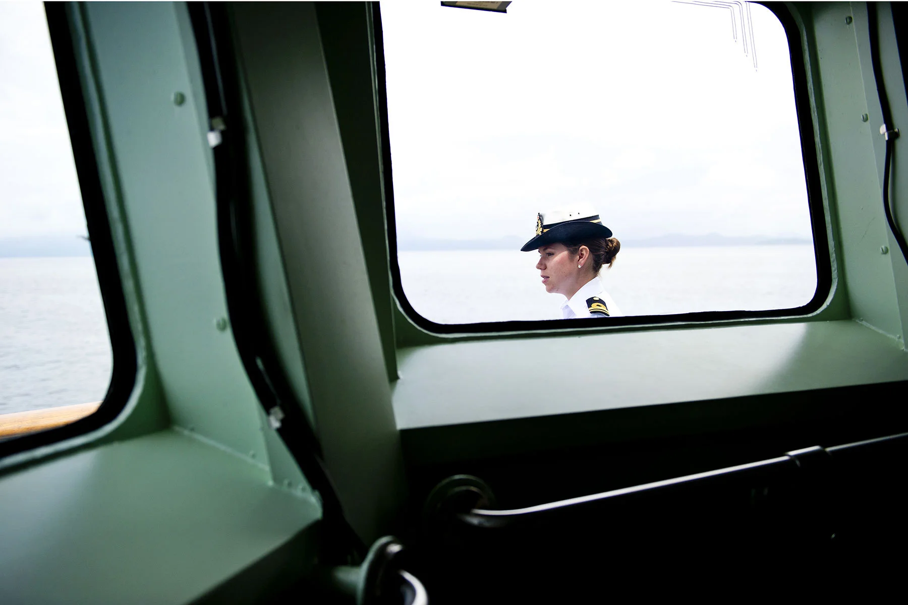 A Canadian Naval sailor waits outside on deck during a tour by the Canadian Navy. Canada's navy warship H.M.C.S Winnipeg provides a tour of it's vessel and operations in Vancouver, BC, Canada on Tuesday, June 10, 2014. Photo by Jimmy Jeong