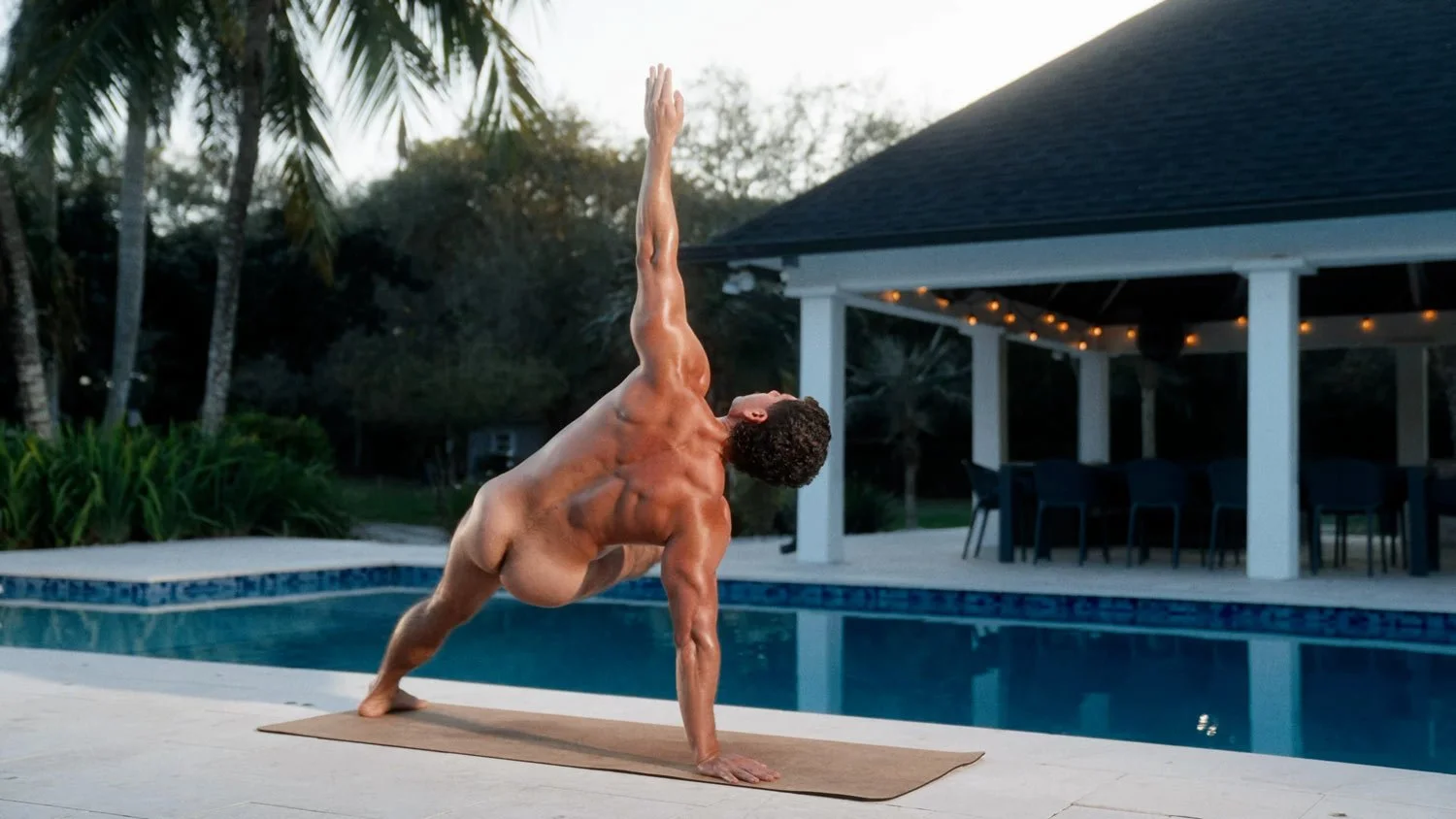 nude muscular man in a side plank pose