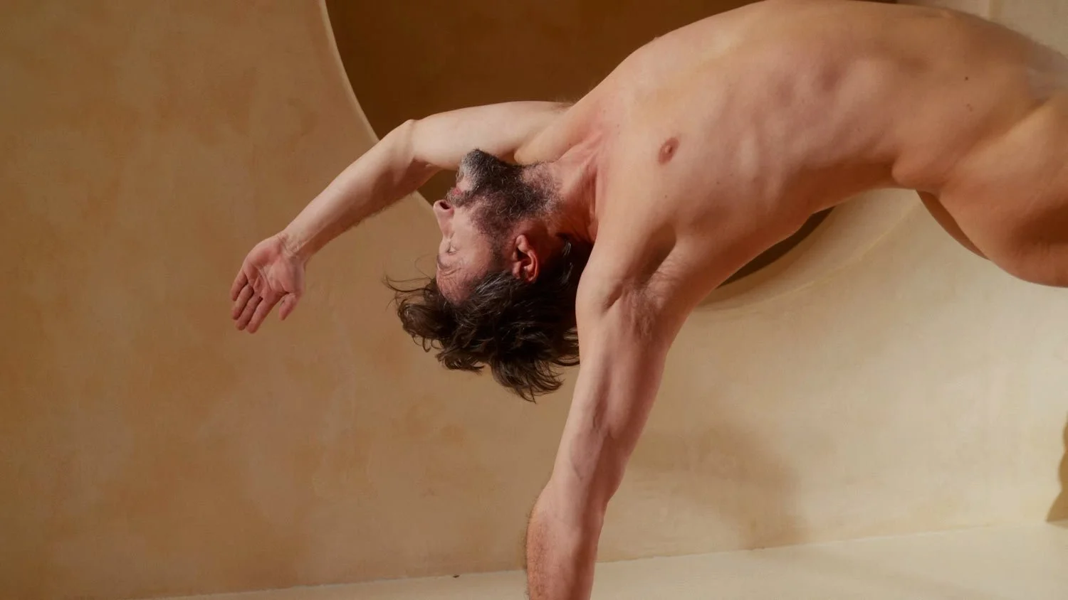close up of nude man in wild thing pose