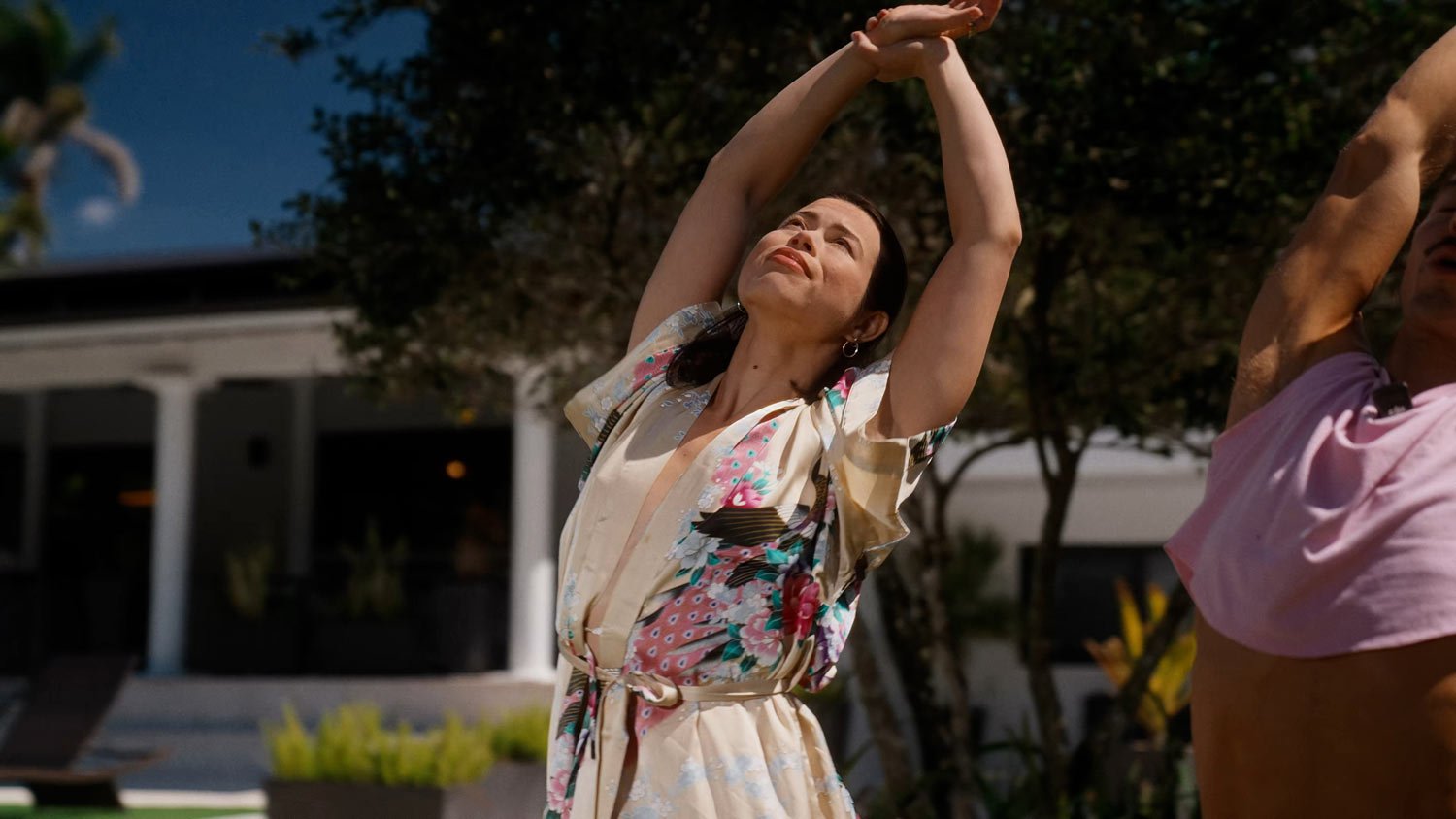 woman doing yoga outside in a standing side stretch