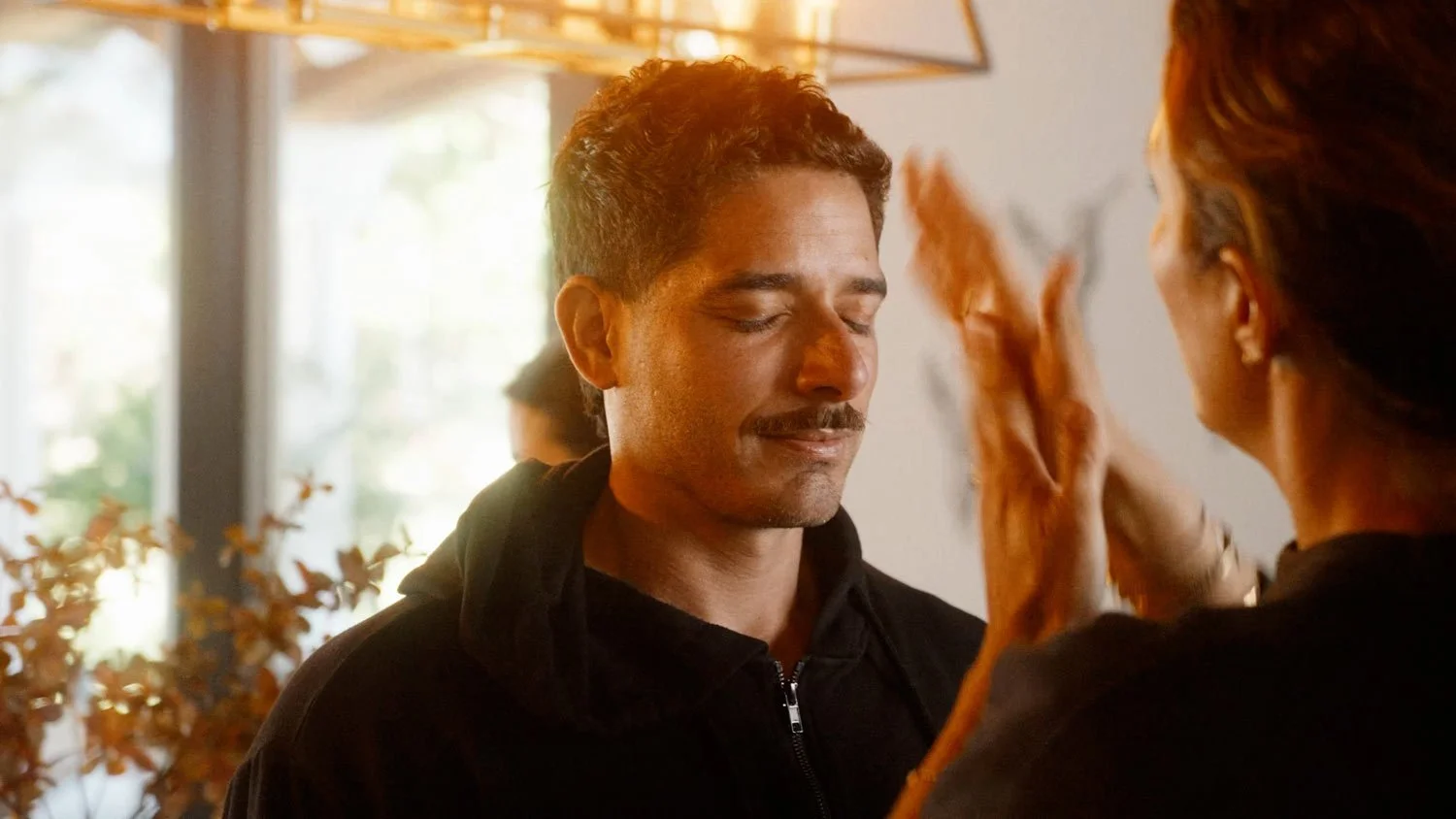 man getting his hair done during golden hour light