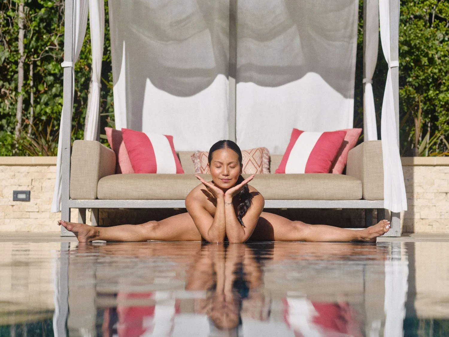 nude woman in wide-angled seated forward bend pose