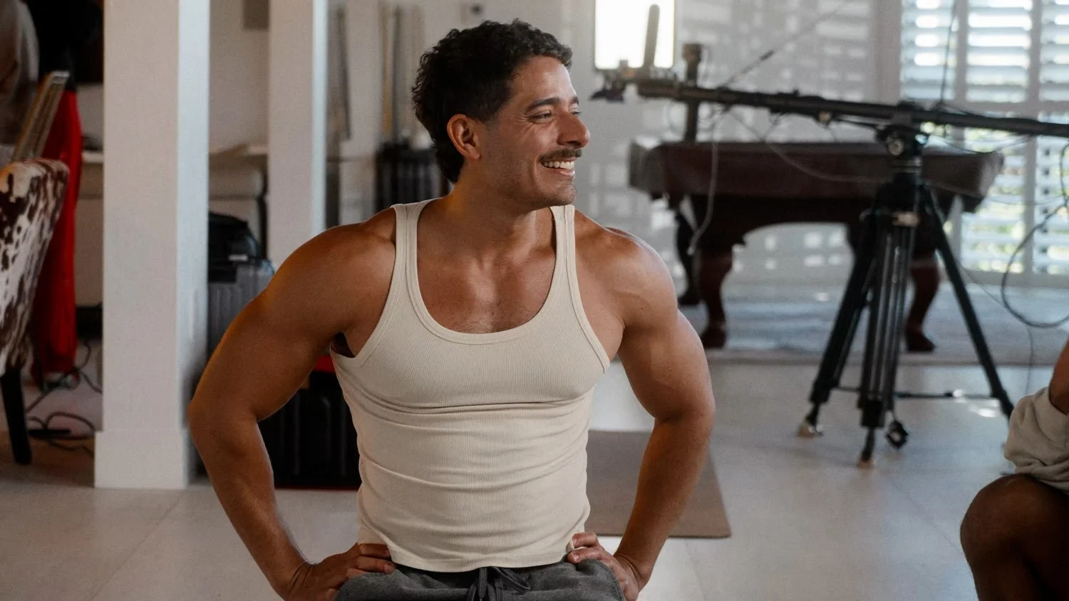 smiling man in tank top