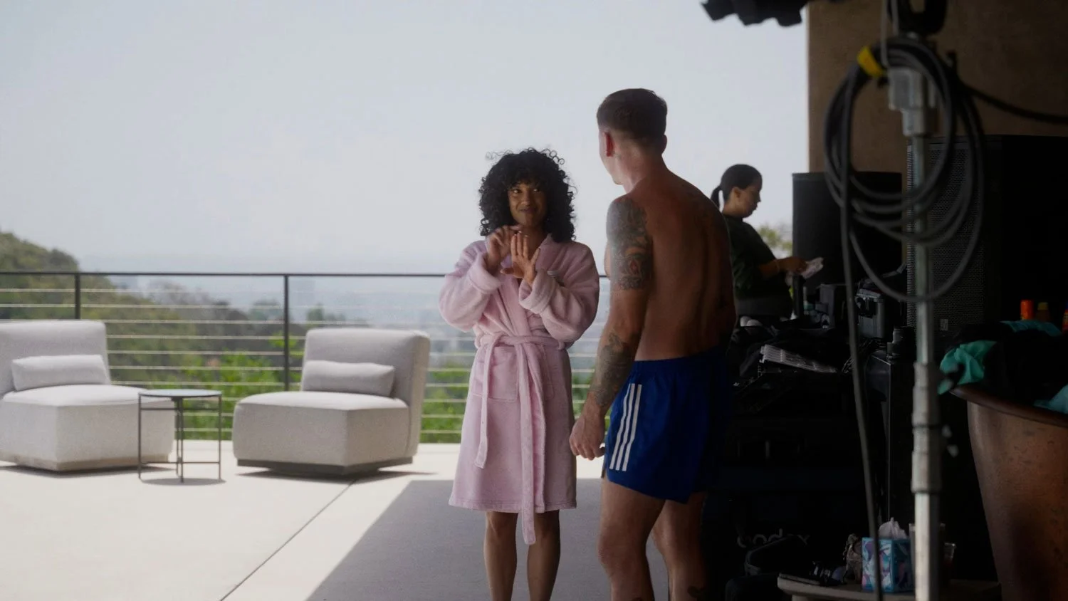 girl in pink robe smiling at man outside