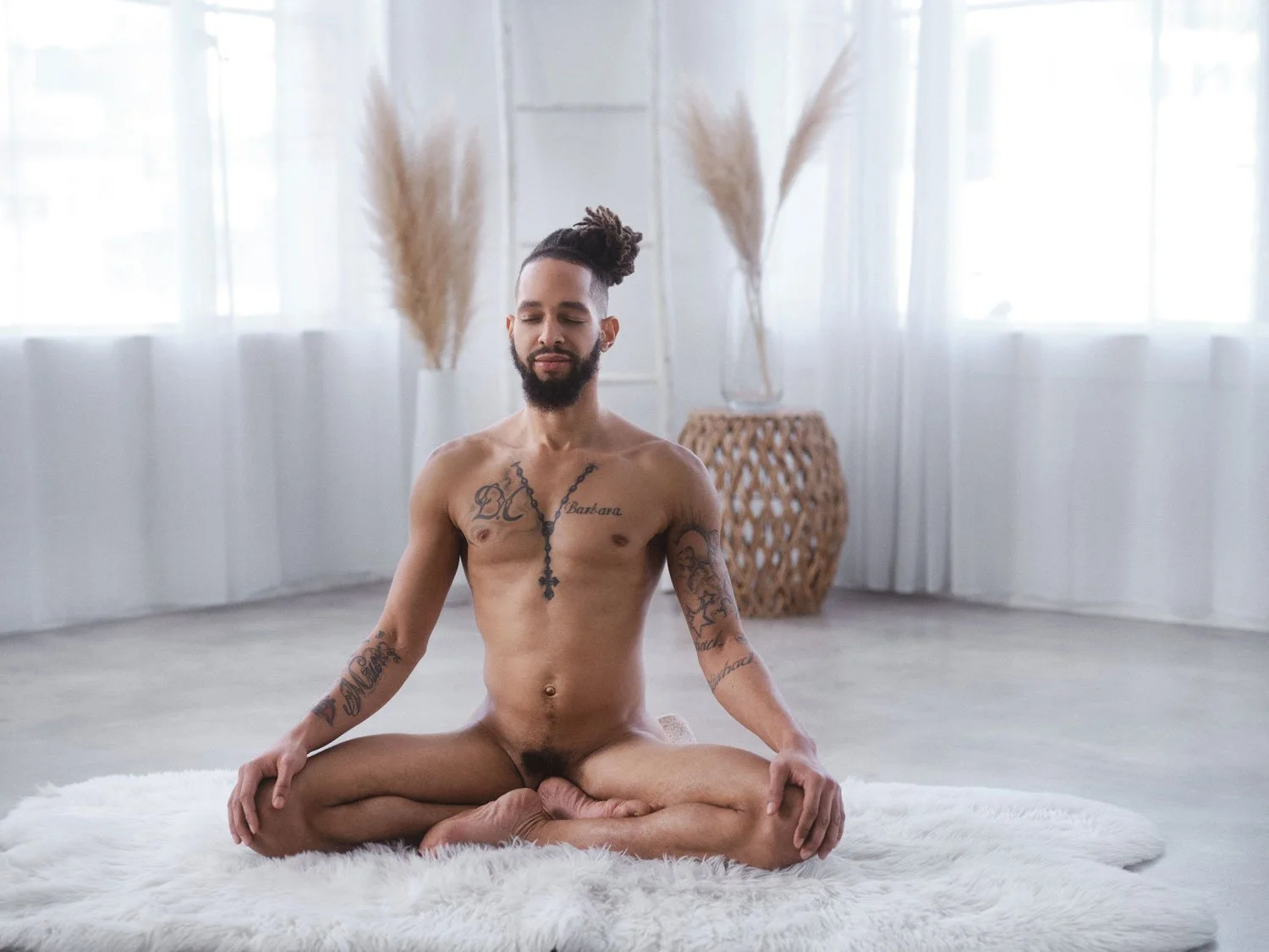 nude male in lotus pose with eyes closed meditating