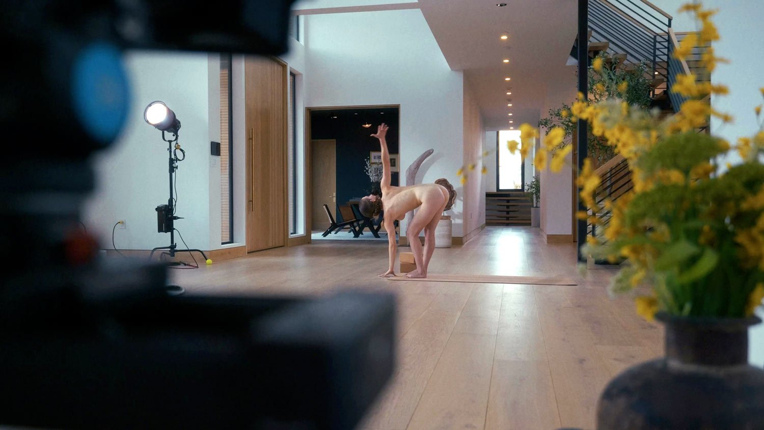 nude woman doing naked yoga on a video set