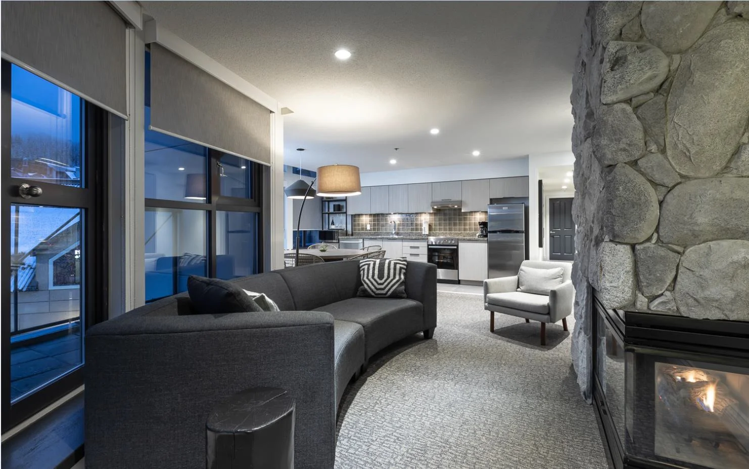 after - custom curved sofa and neutral palette enhance the openness of the space