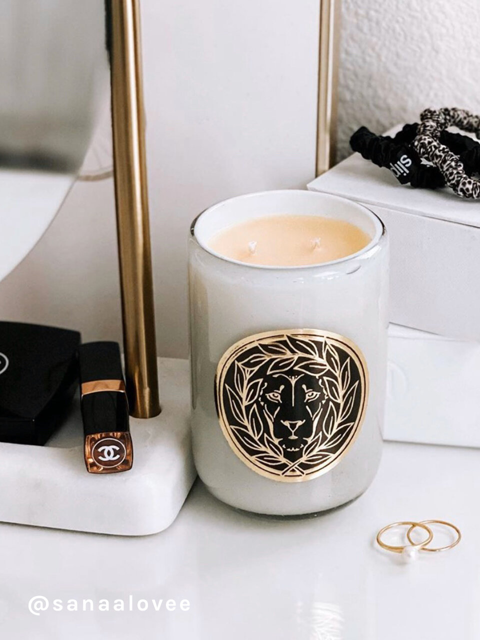 A white beeswax candle next to a mirror on a vanity, Luxury Fragrance Candles, Leone Collection