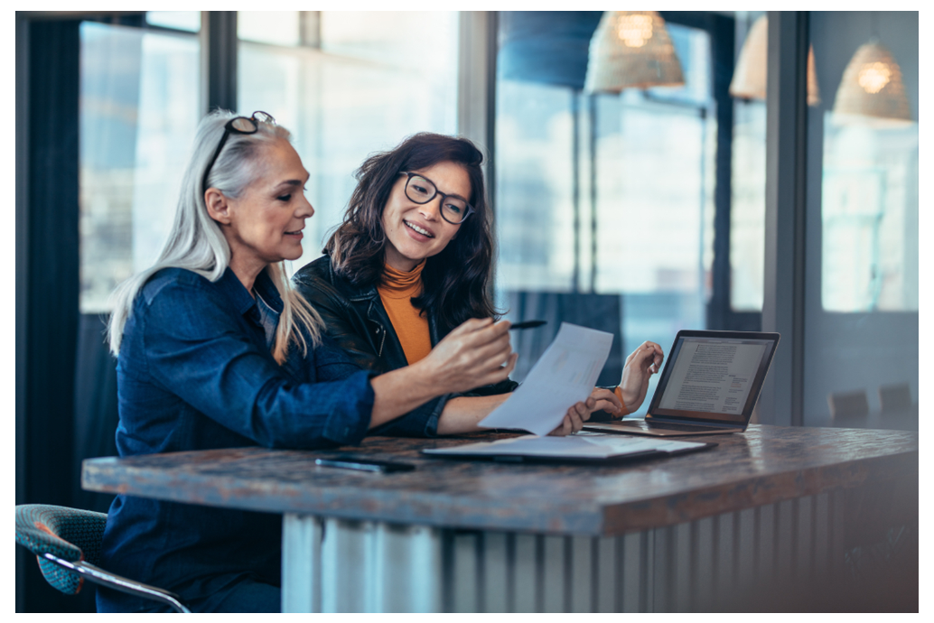 two women looking at a report