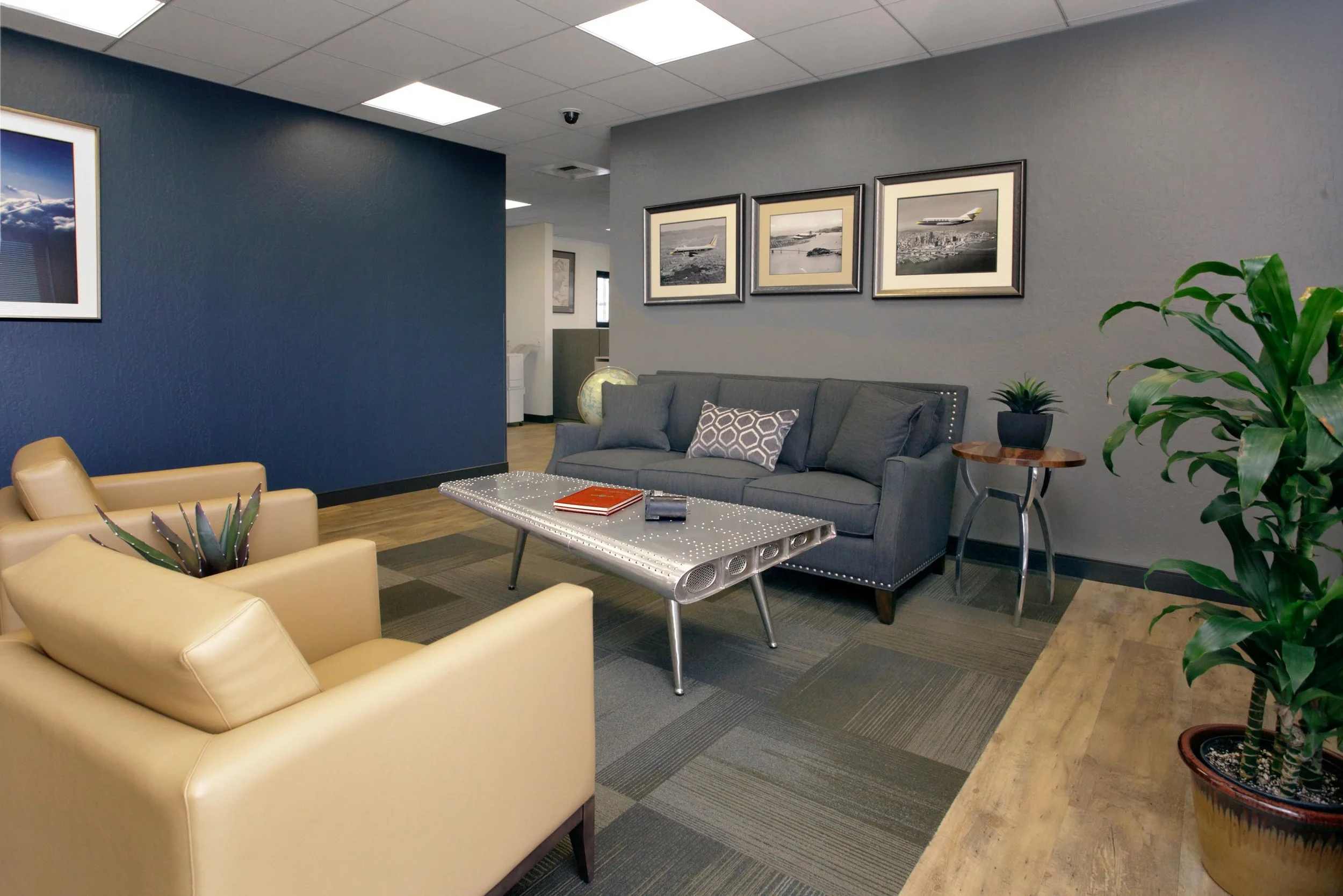 Guest lounge with navy blue and gray furnishing, sofa sets and vinyl tile flooring