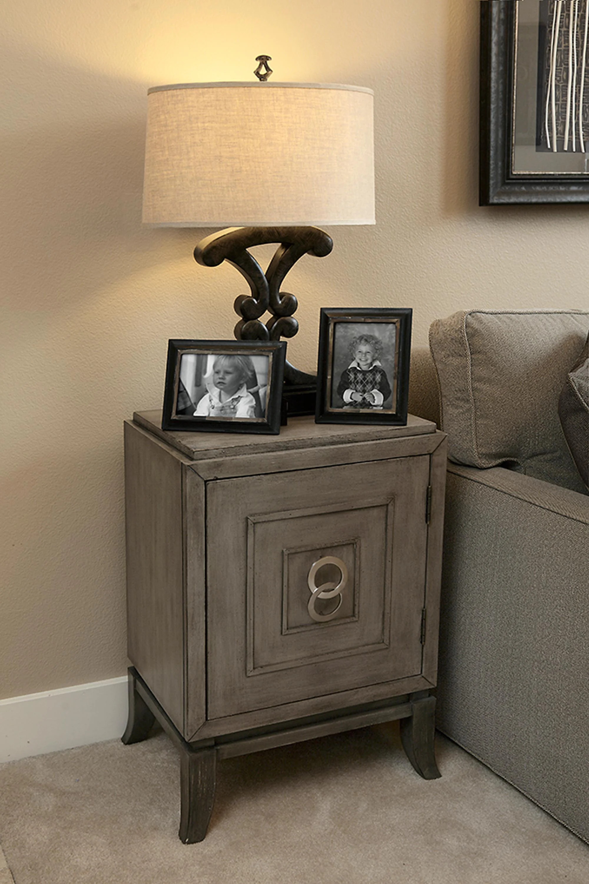 Elegant two picture frame and lamp above the cabinet