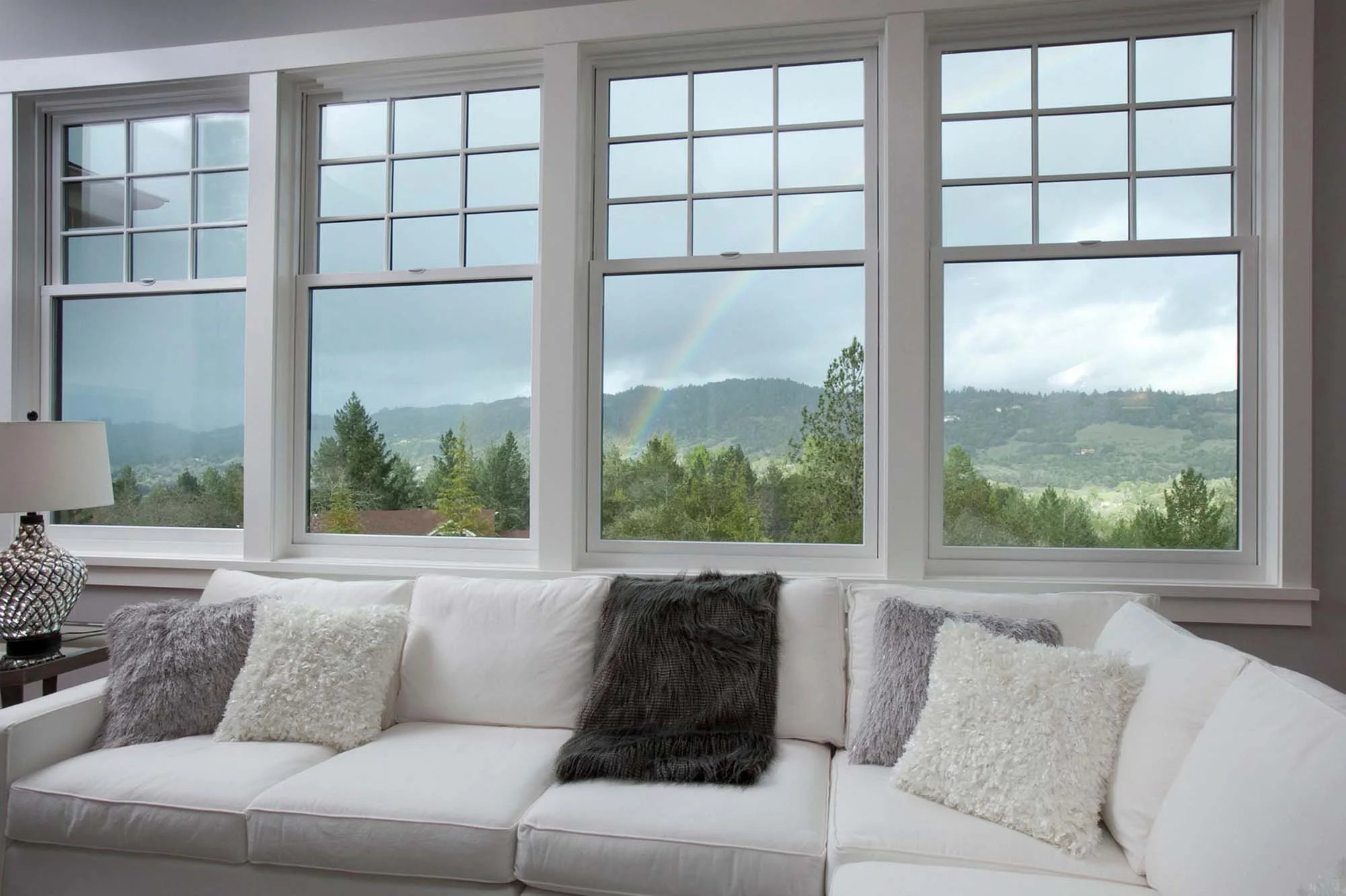 Living room with white sofa and mountain view window