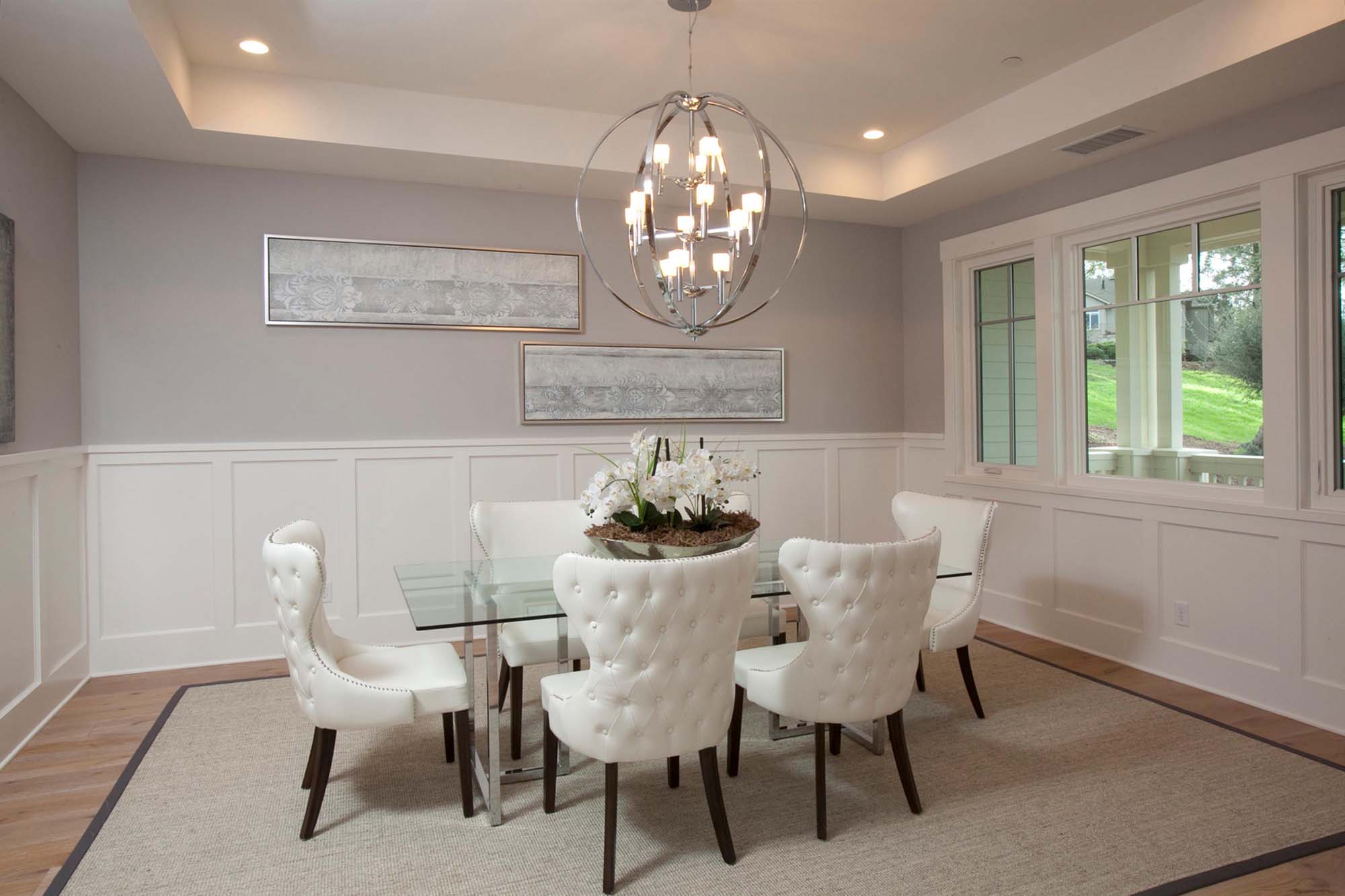 Modern living room with sets of chairs, table and chandelier